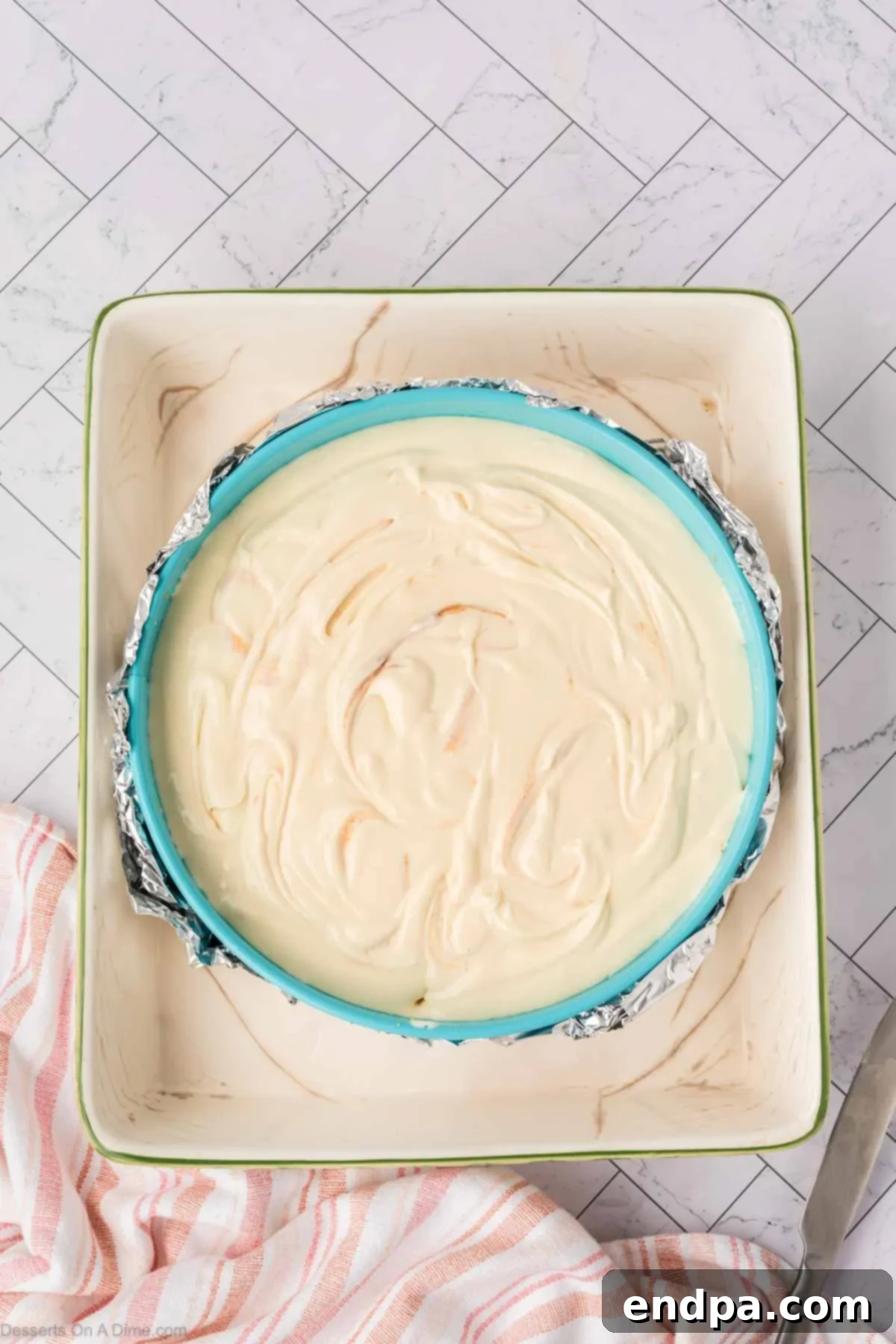 Velvet Sweet Potato Cheesecake 16 Swirled cheesecake batter in a springform pan, ready for baking.