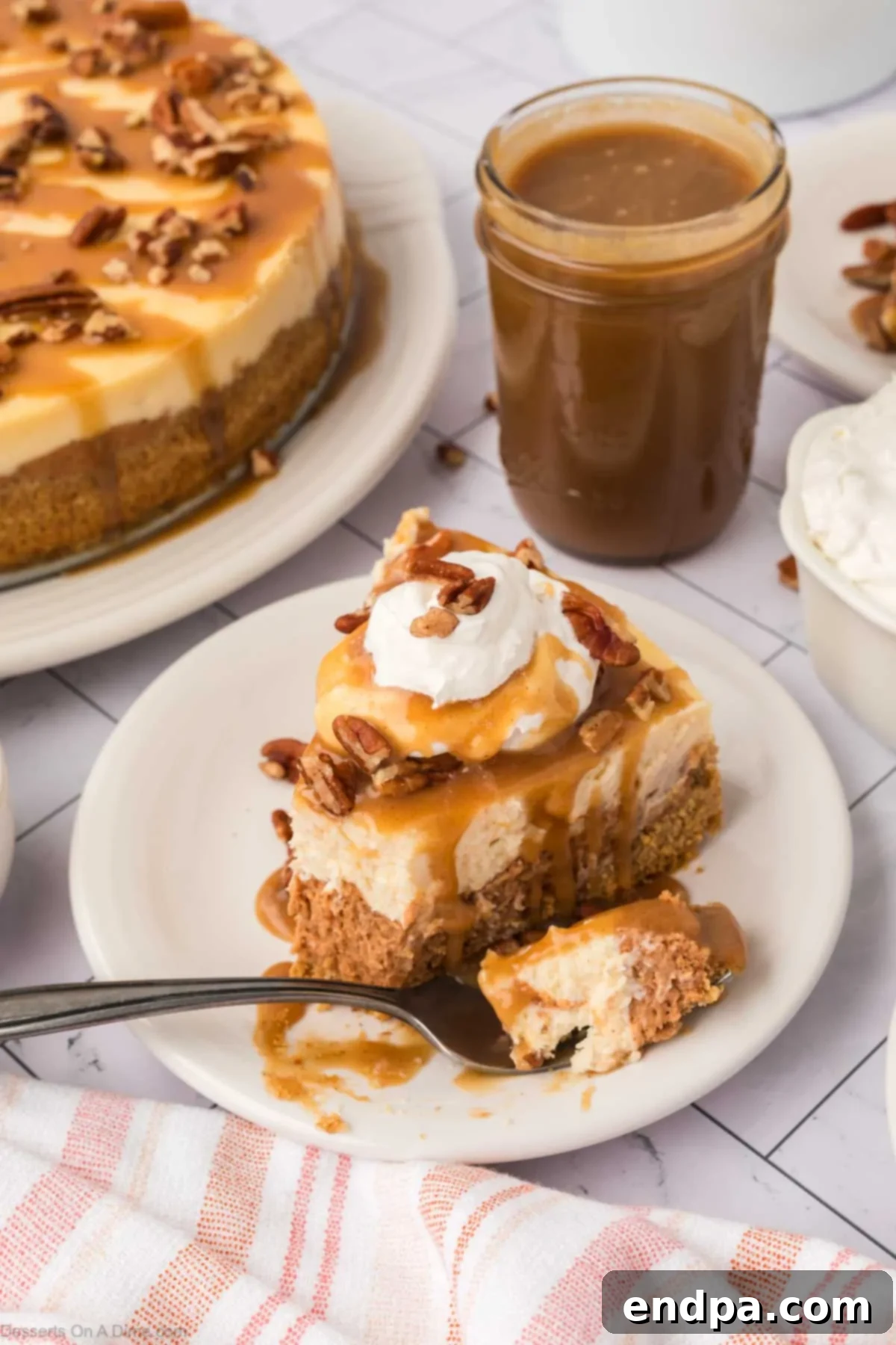 Velvet Sweet Potato Cheesecake 22 Sweet Potato Cheesecake with caramel topping, served on a white plate with a fork.