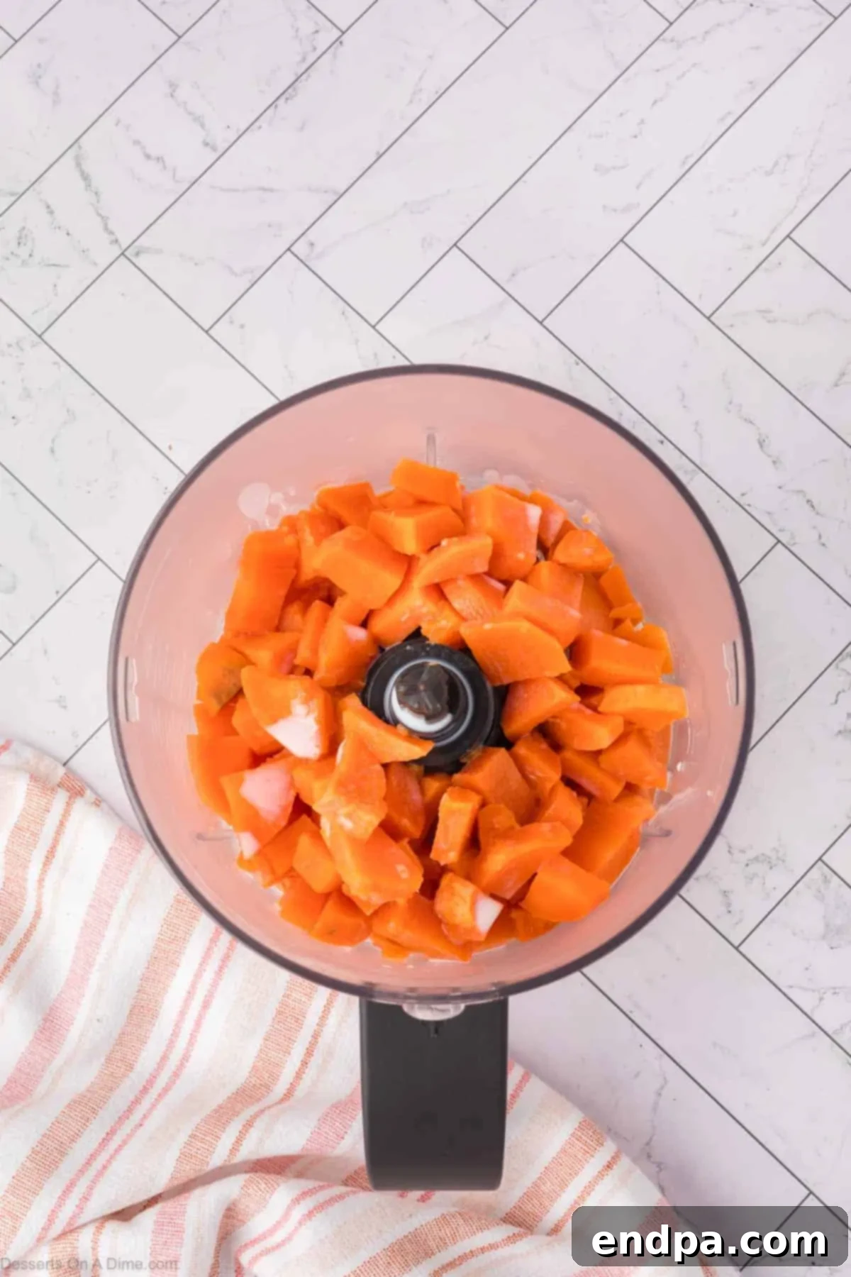 Velvet Sweet Potato Cheesecake 5 Cooked diced sweet potatoes with milk in a food processor, ready for blending.