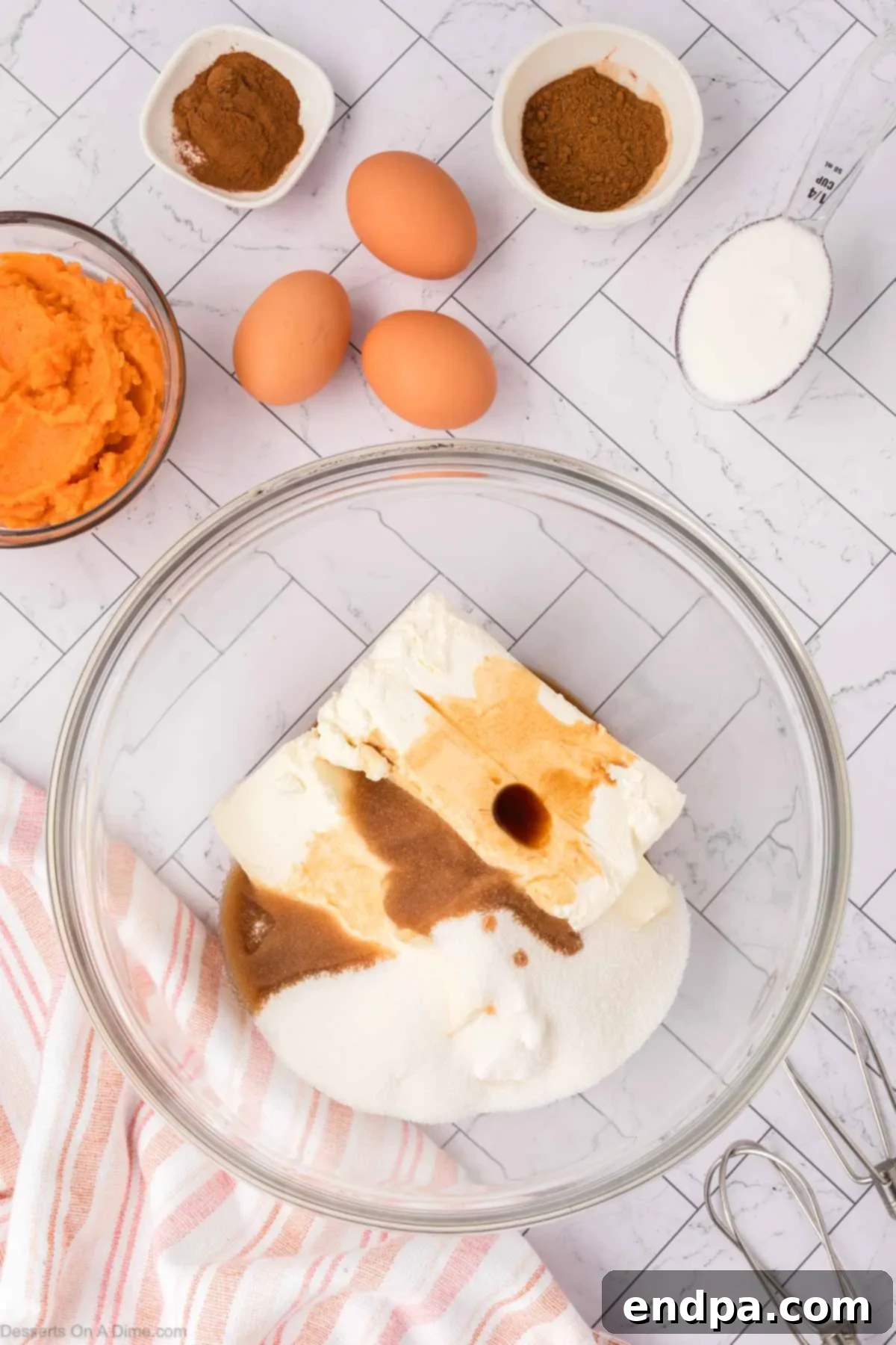 Velvet Sweet Potato Cheesecake 9 Cream cheese and sugar being mixed in a bowl until smooth.