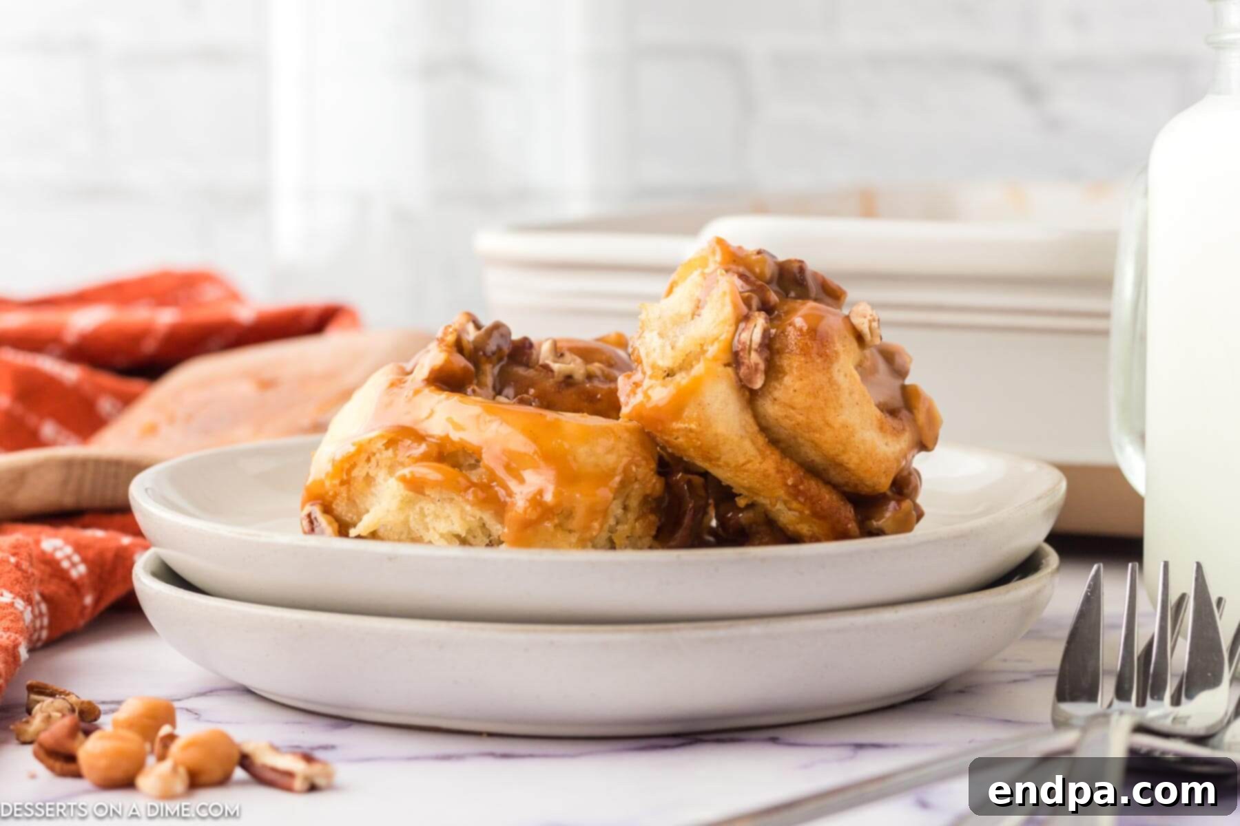 Warm & Wonderful: Baking Comfort After Thanksgiving 2 Plate with caramel pecan cinnamon rolls. A warm and inviting dessert.