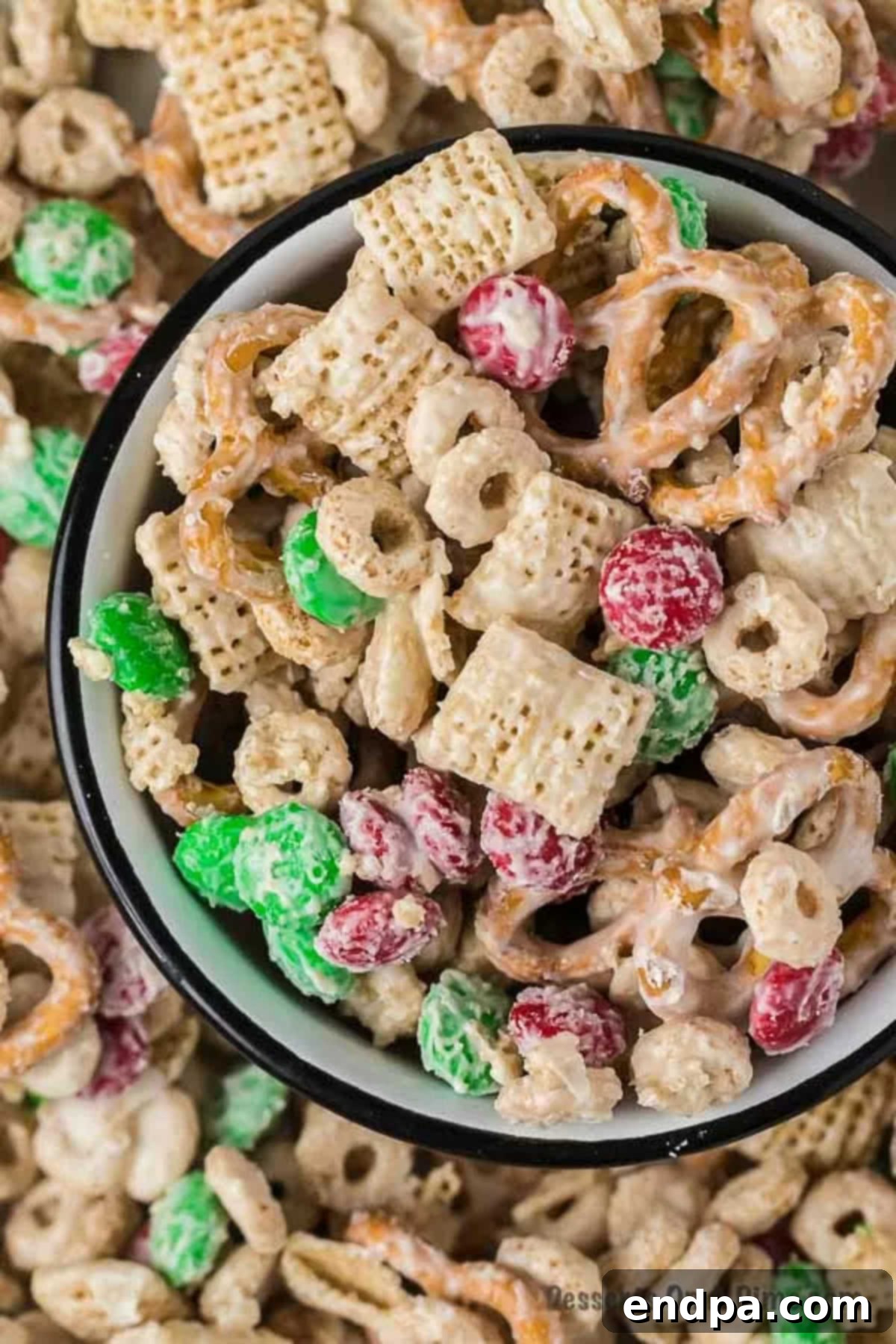 Irresistible Christmas Chex Mix 2 Bowl of Christmas Crack Chex Mix with festive red and green M&M's.
