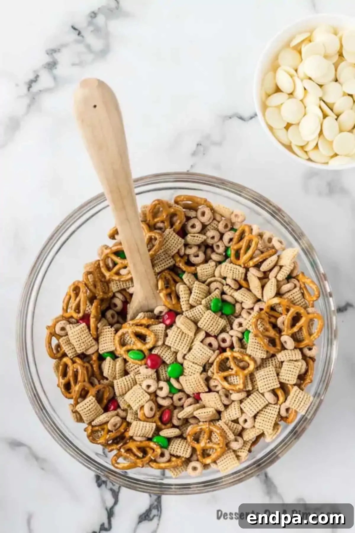 Irresistible Christmas Chex Mix 3 Mixing bowl with cereal, candy and pretzels combined.
