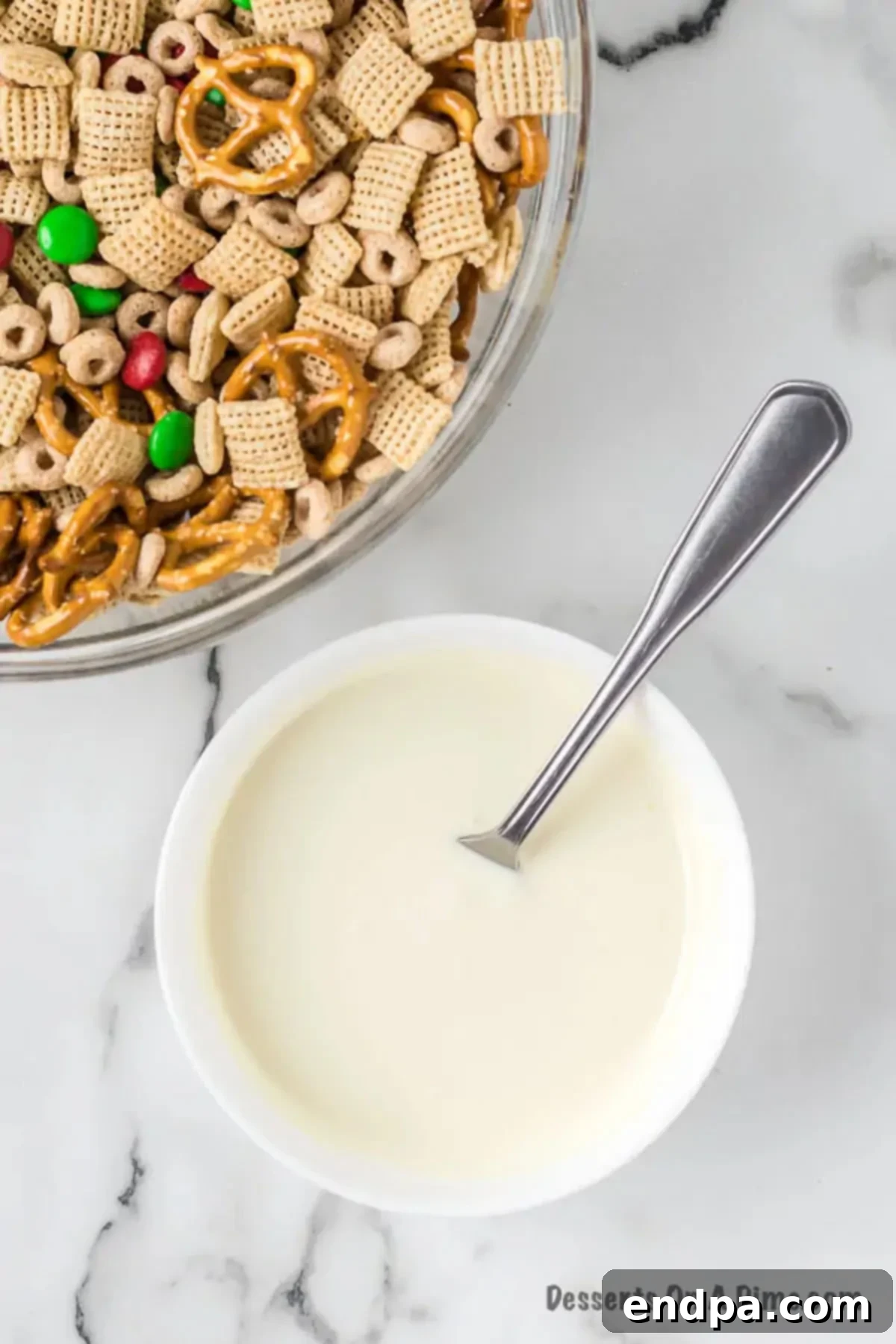 Irresistible Christmas Chex Mix 4 Melted white chocolate in a bowl.