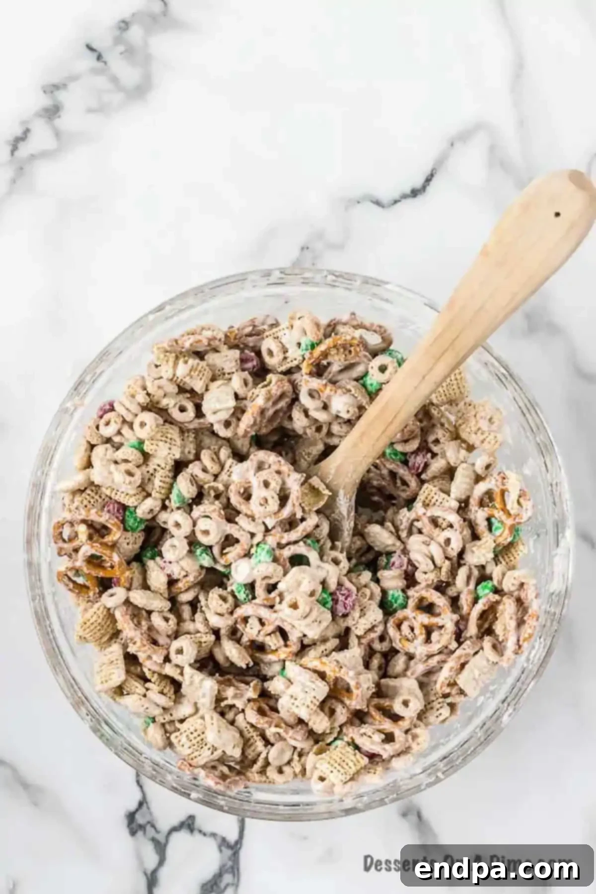 Irresistible Christmas Chex Mix 5 Melted white chocolate poured over the cereal mixture.