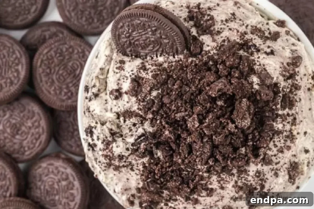 Oreo fluff in a bowl topped with more cookies.