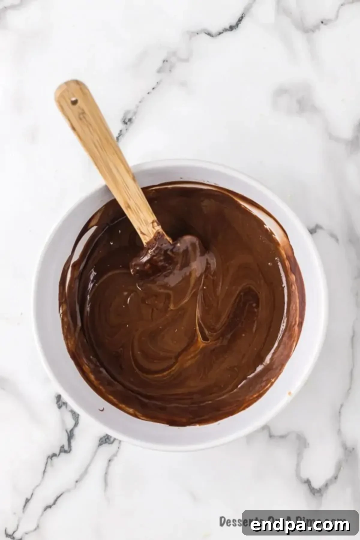 A bowl showing the smooth, combined mixture of chocolate and peanut butter after stirring.