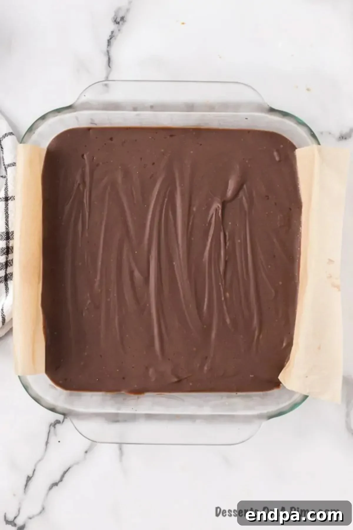 The finished, hardened block of chocolate peanut butter fudge in the pan, ready for cutting.