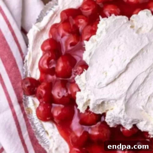 39 Must-Try Pie Recipes 4 A vibrant No-Bake Cherry Pie featuring a sweet cream cheese filling and a glossy cherry topping in a graham cracker crust.