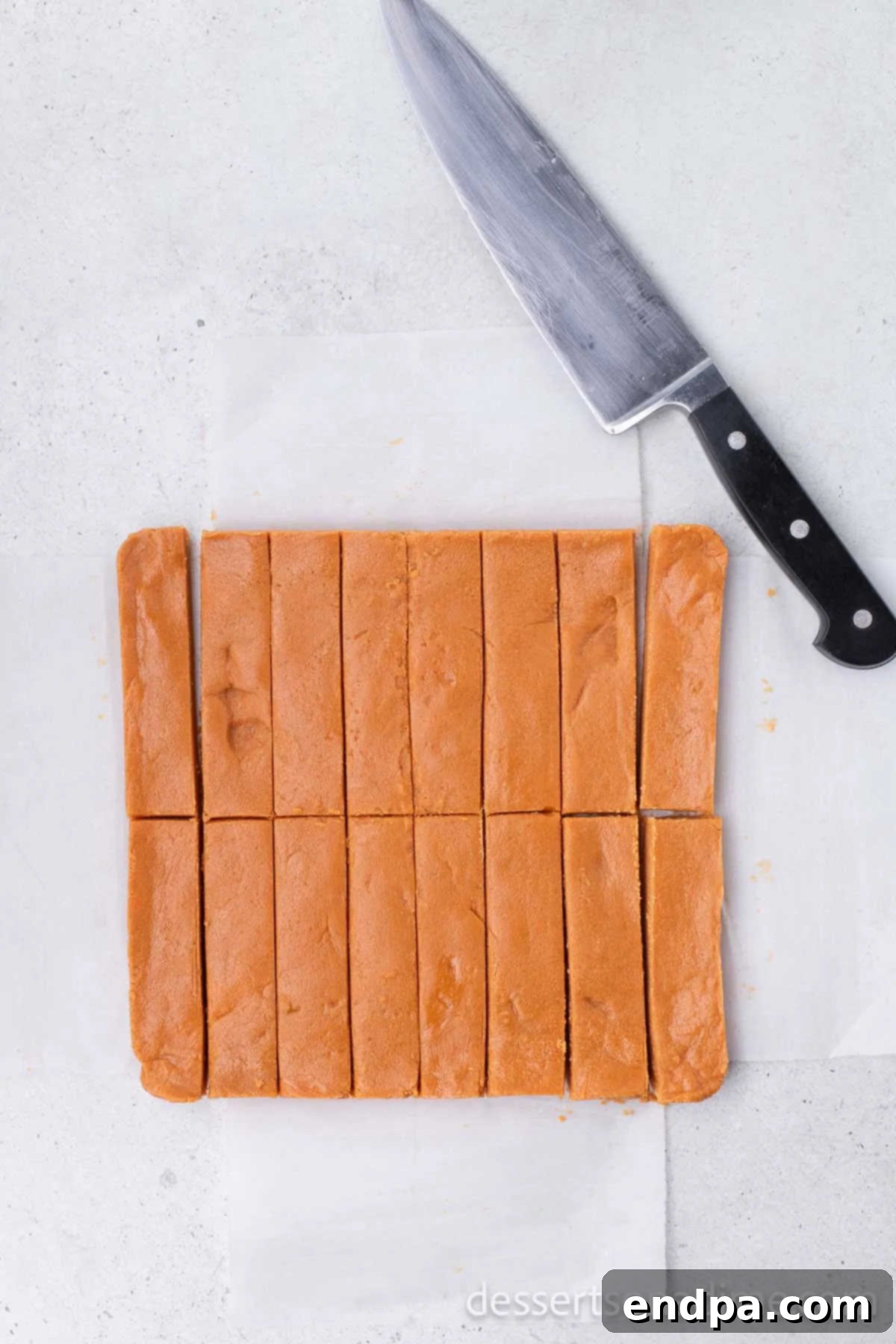 DIY Butterfinger Bliss 6 The hardened Butterfinger mixture neatly cut into individual bar shapes before dipping in chocolate.