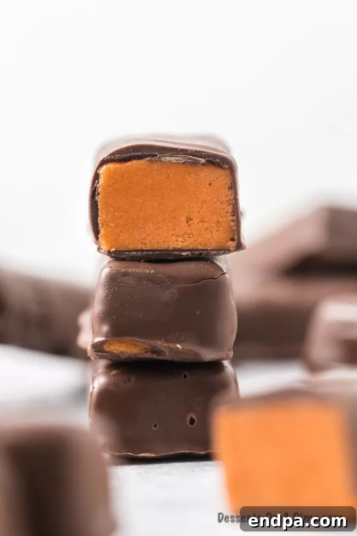 DIY Butterfinger Bliss 8 A close-up view of a homemade Butterfinger bar, sliced in half to show the crunchy, golden peanut butter filling inside its perfectly set chocolate shell.