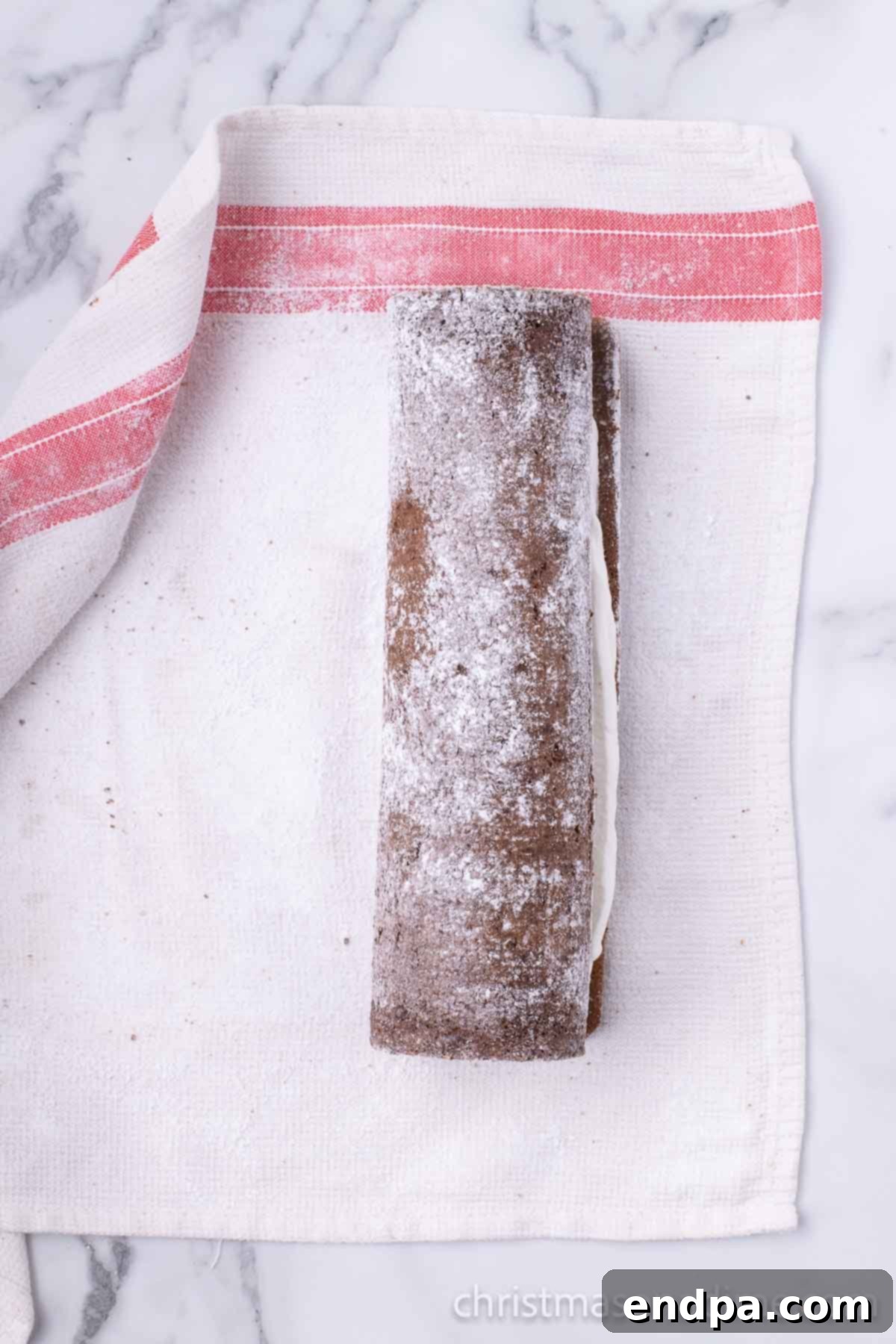 Cake rolled up and cooling on towel. 