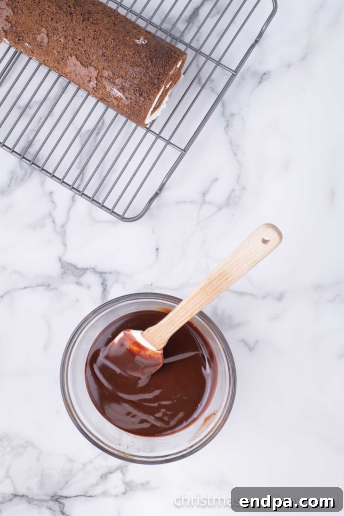 Chocolate in bowl melted and ready to use on cake. 