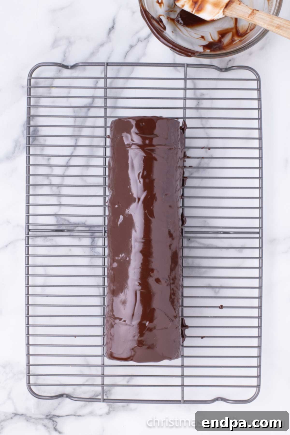 Chocolate topping spread on cake. 