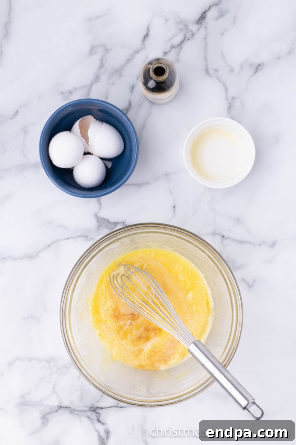 Separate mixing bowl with eggs and sugar. 