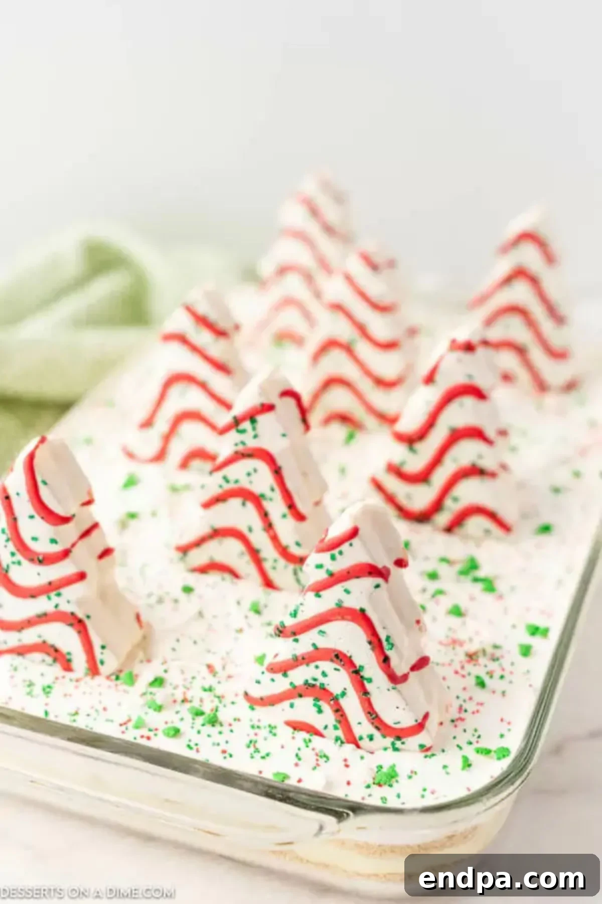 A closer look at the Christmas dirt cake in a baking dish, showcasing its layers and festive toppings.