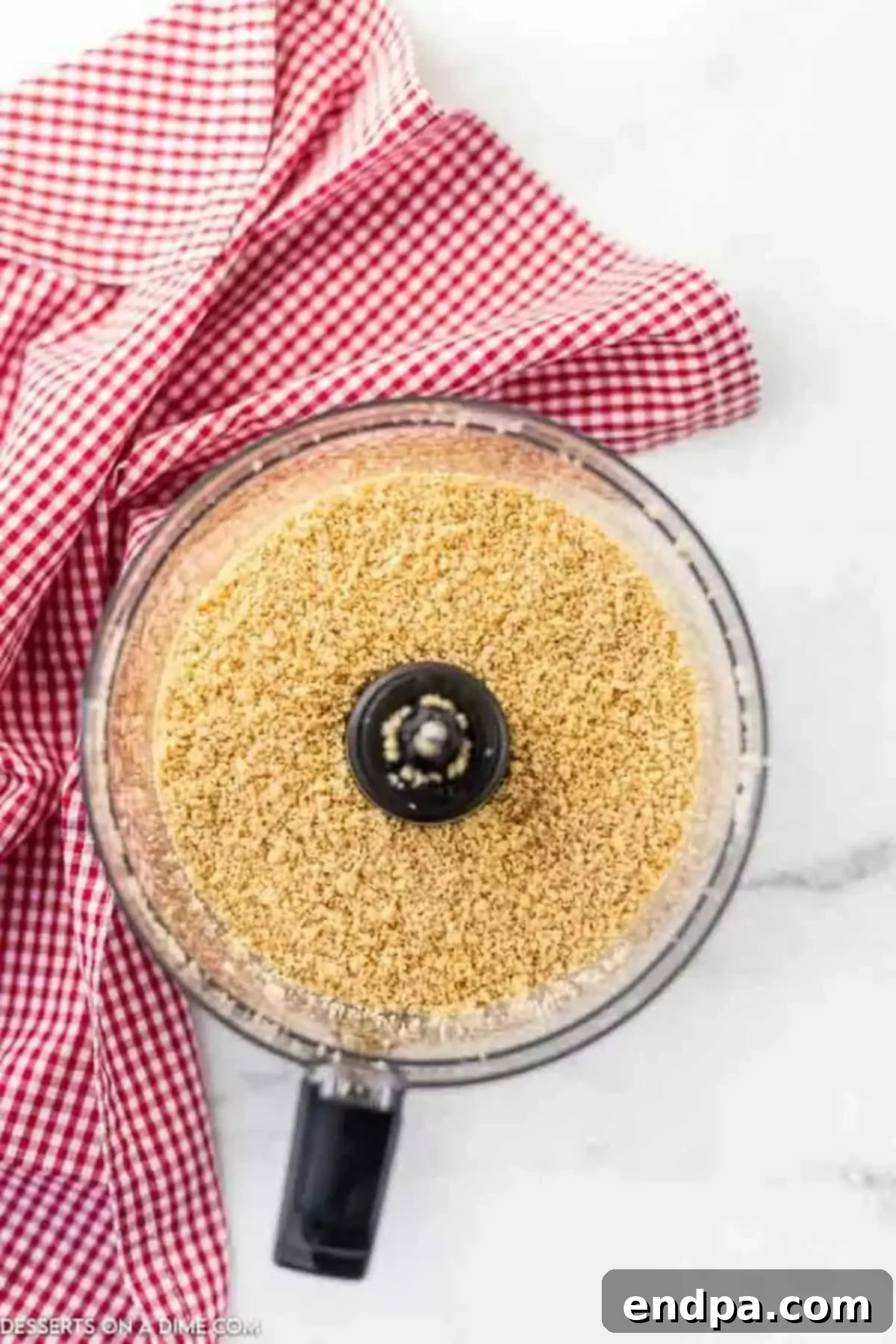 Golden Oreo cookie crumbs in a food processor.