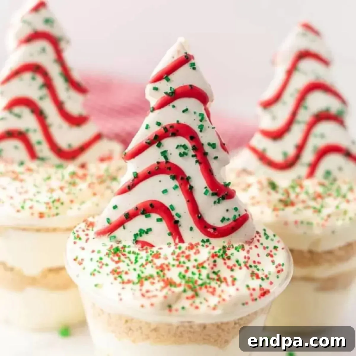 Christmas tree dirt cups grouped together on a festive background.