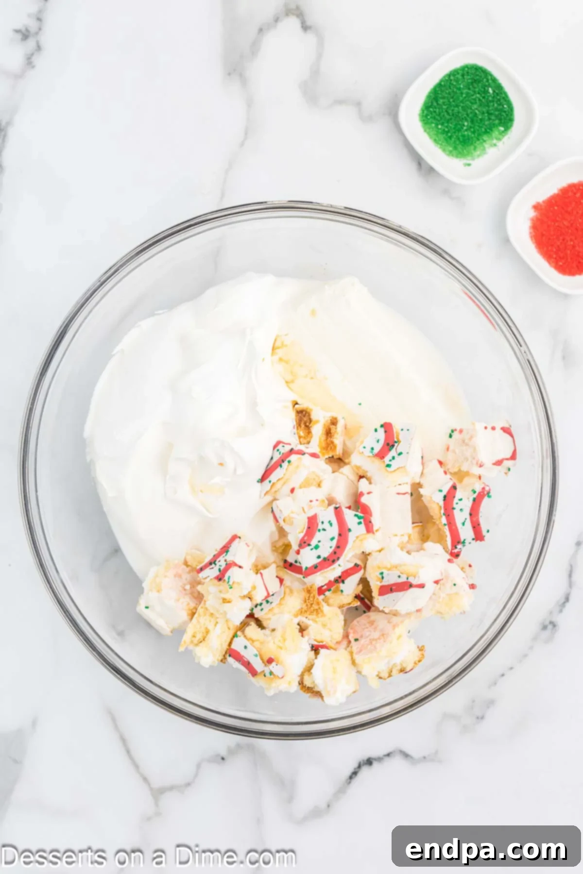 All the dip ingredients, including chopped Little Debbie Christmas Tree Cakes, cream cheese, cool whip, vanilla, and milk, placed in a large mixing bowl, ready to be combined.