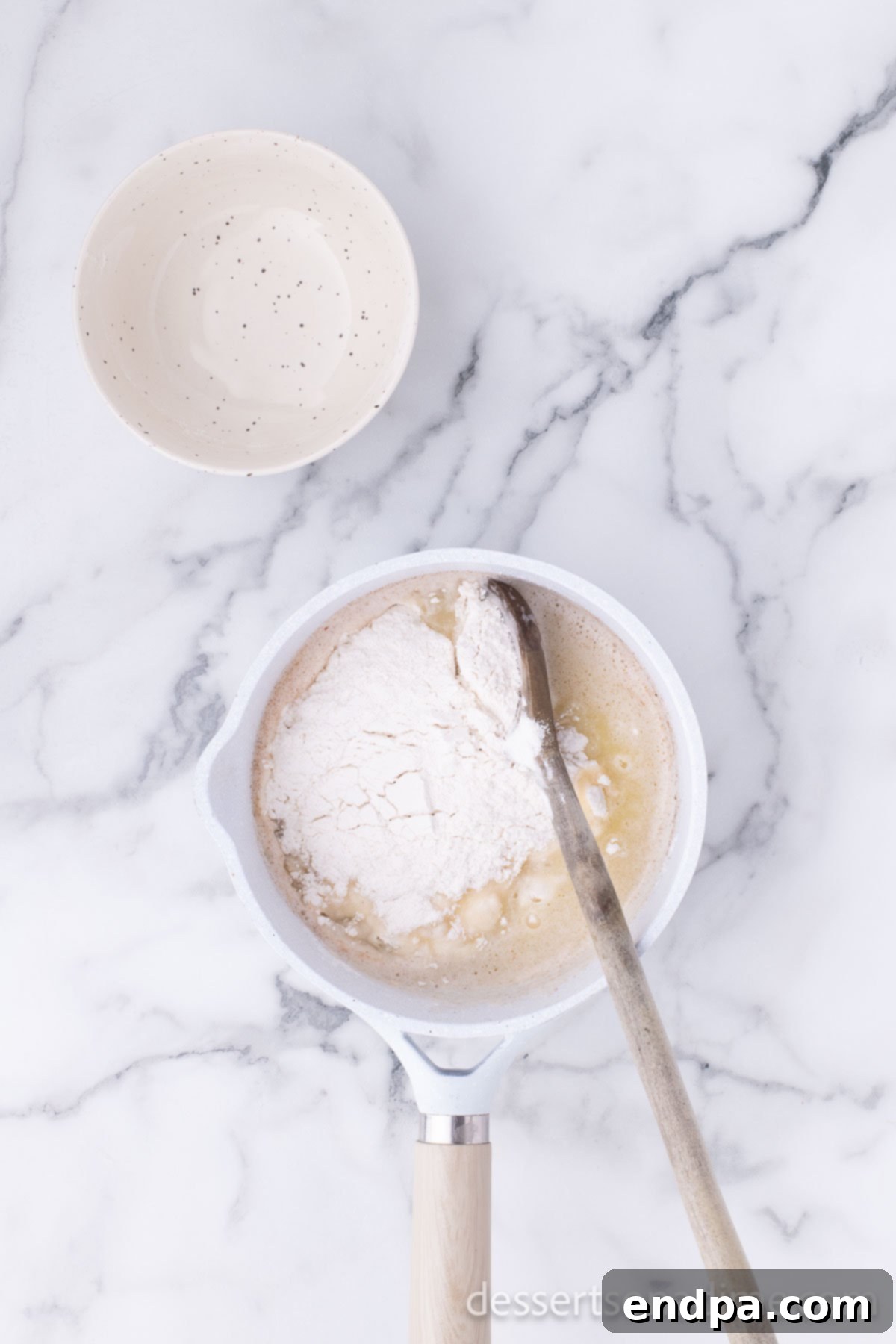Flour added to mixture in saucepan. 