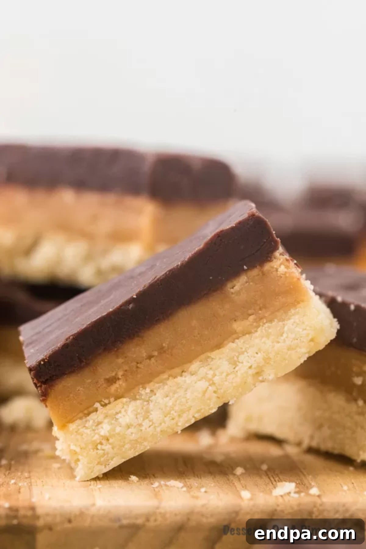 Make Your Own Twix Bars 16 Close-up photo of a single homemade Twix bar, showing its perfectly defined layers.