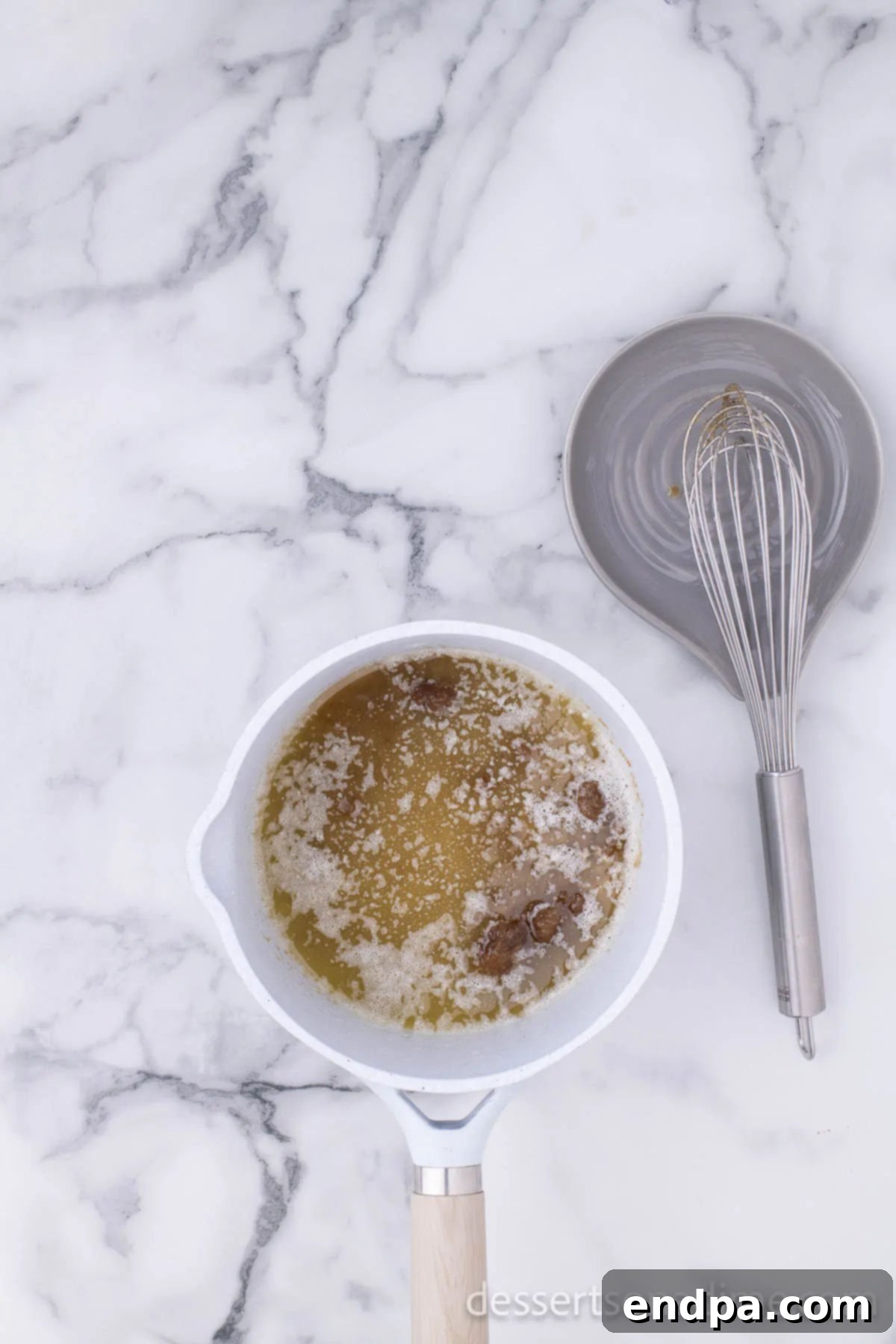 Make Your Own Twix Bars 9 Brown sugar added to melted butter in a saucepan, being stirred to dissolve.