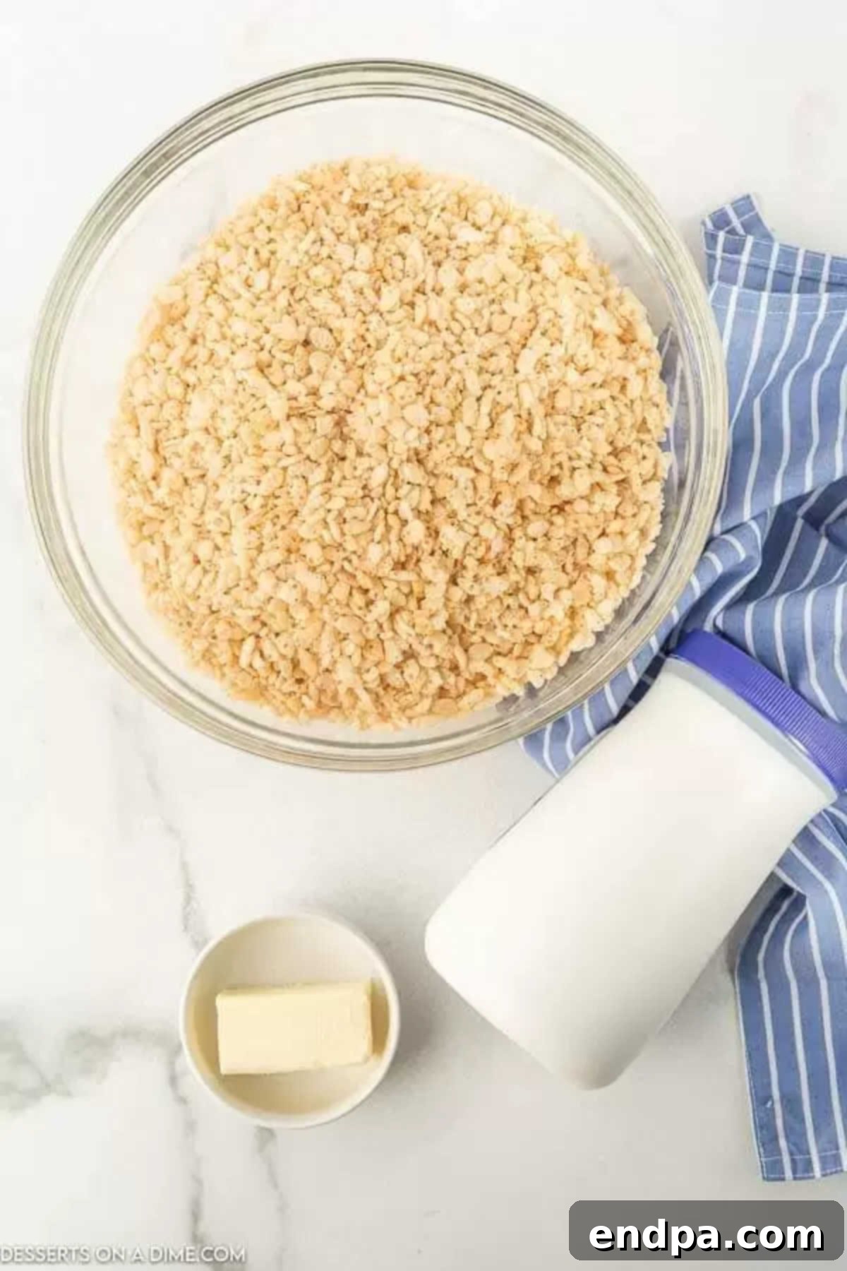 Cloud-Like Marshmallow Fluff Krispie Treats 3 Three key ingredients for Rice Krispie treats: a box of Rice Krispies cereal, a jar of marshmallow fluff, and a stick of butter.