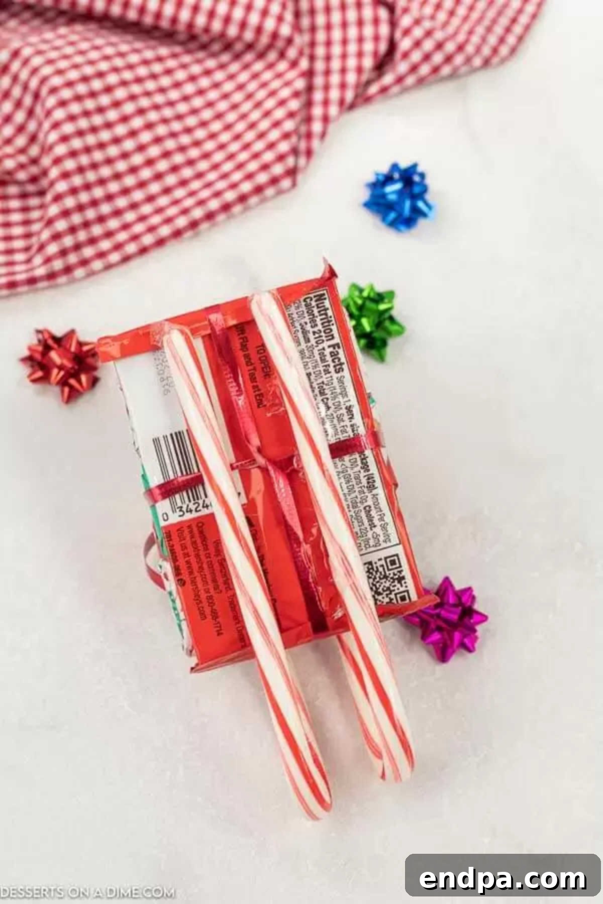 Candy canes attached to the bottom of the chocolate bar base.