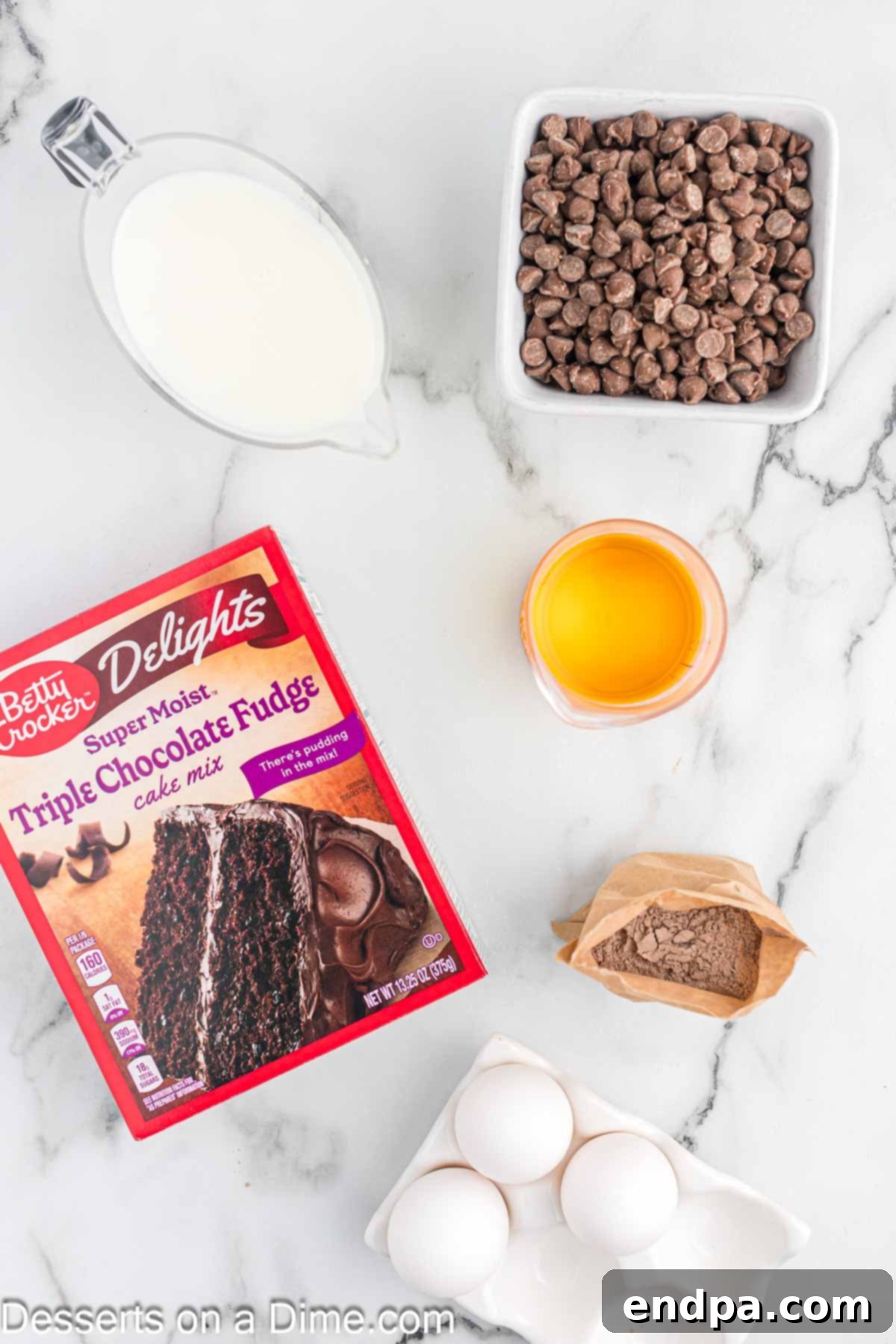 Effortless Slow Cooker Molten Chocolate Cake 3 Ingredients for lava cake: cake mix, chocolate chips, oil, eggs, milk, pudding mix laid out on a table.