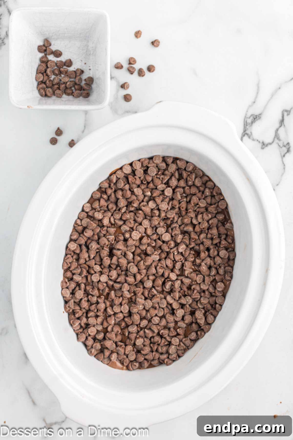 Effortless Slow Cooker Molten Chocolate Cake 7 Chocolate chips sprinkled over the pudding layer in the crock pot.