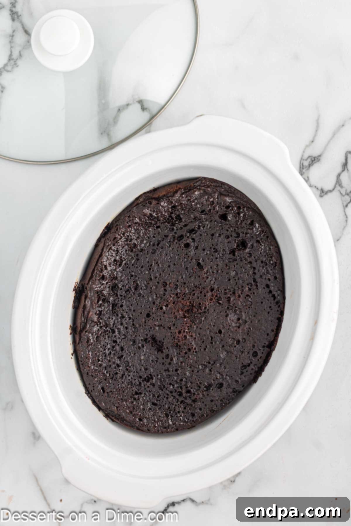 Effortless Slow Cooker Molten Chocolate Cake 8 Crockpot with cake cooking inside, lid on.