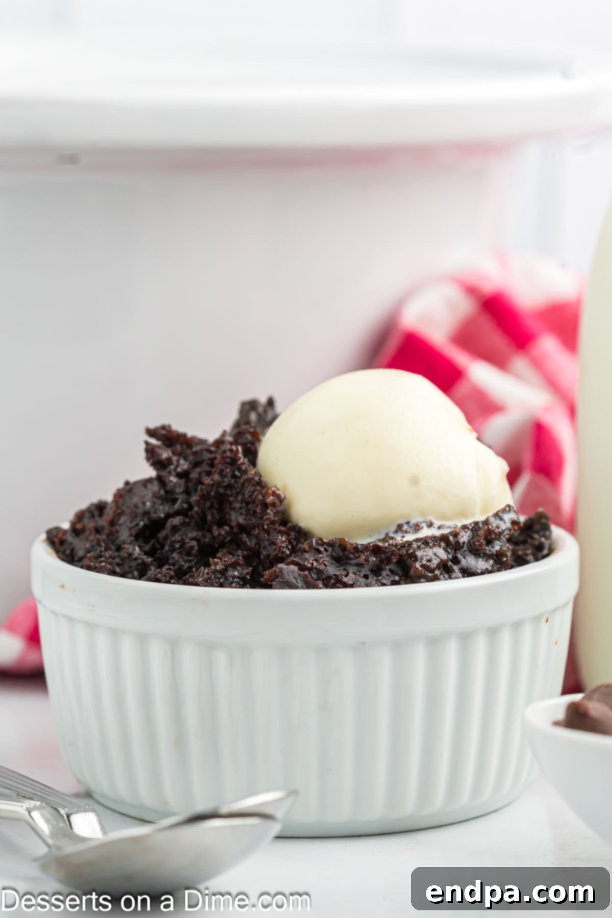 Effortless Slow Cooker Molten Chocolate Cake 9 Serving of chocolate lava cake topped with vanilla ice cream.