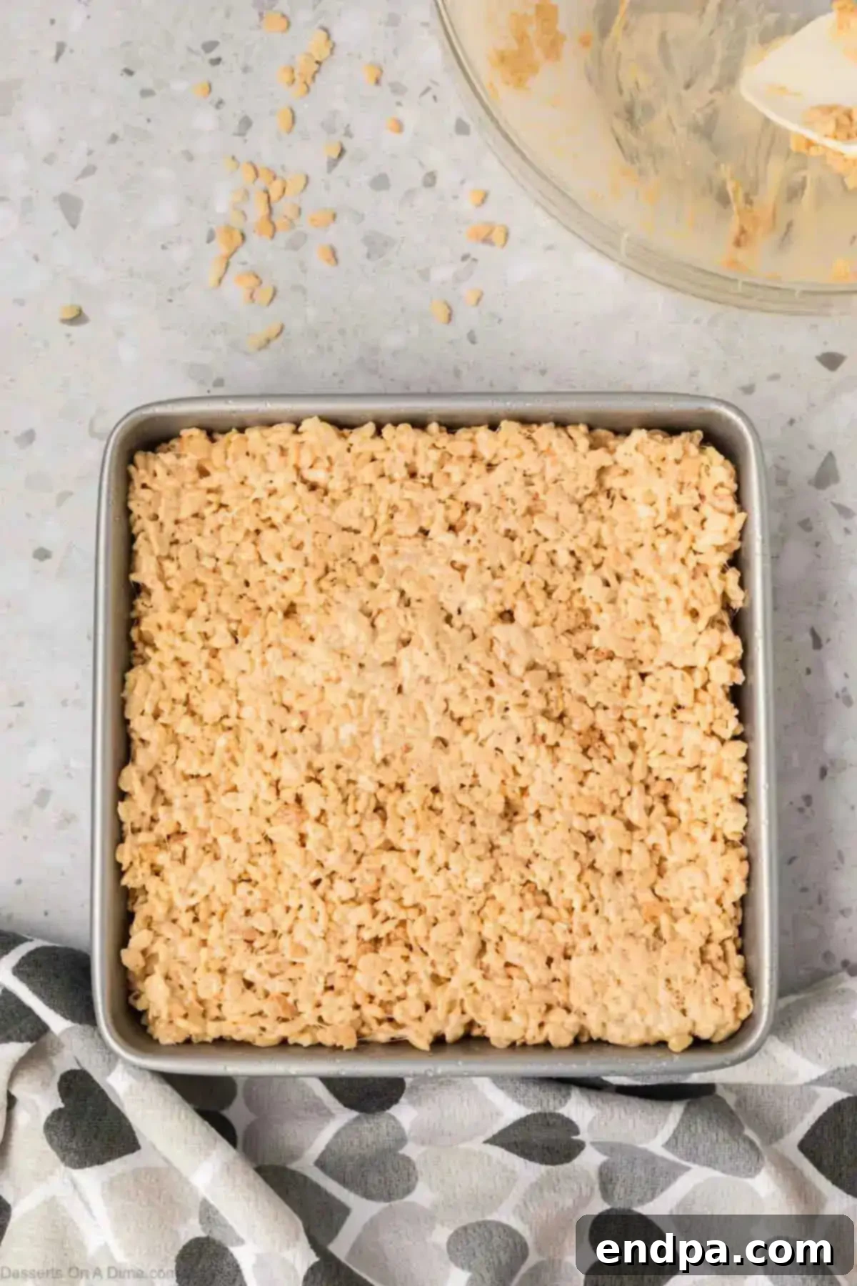 Cereal mixture pressed into baking dish.