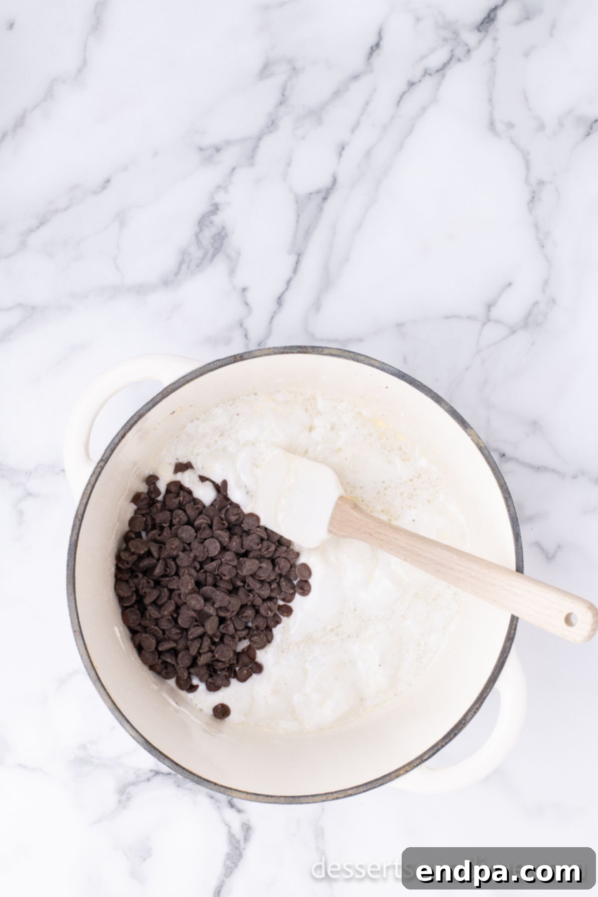 Campfire Delight Cake 5 A rich chocolate mixture, combined with marshmallows and butter, melting in a saucepan on the stovetop.