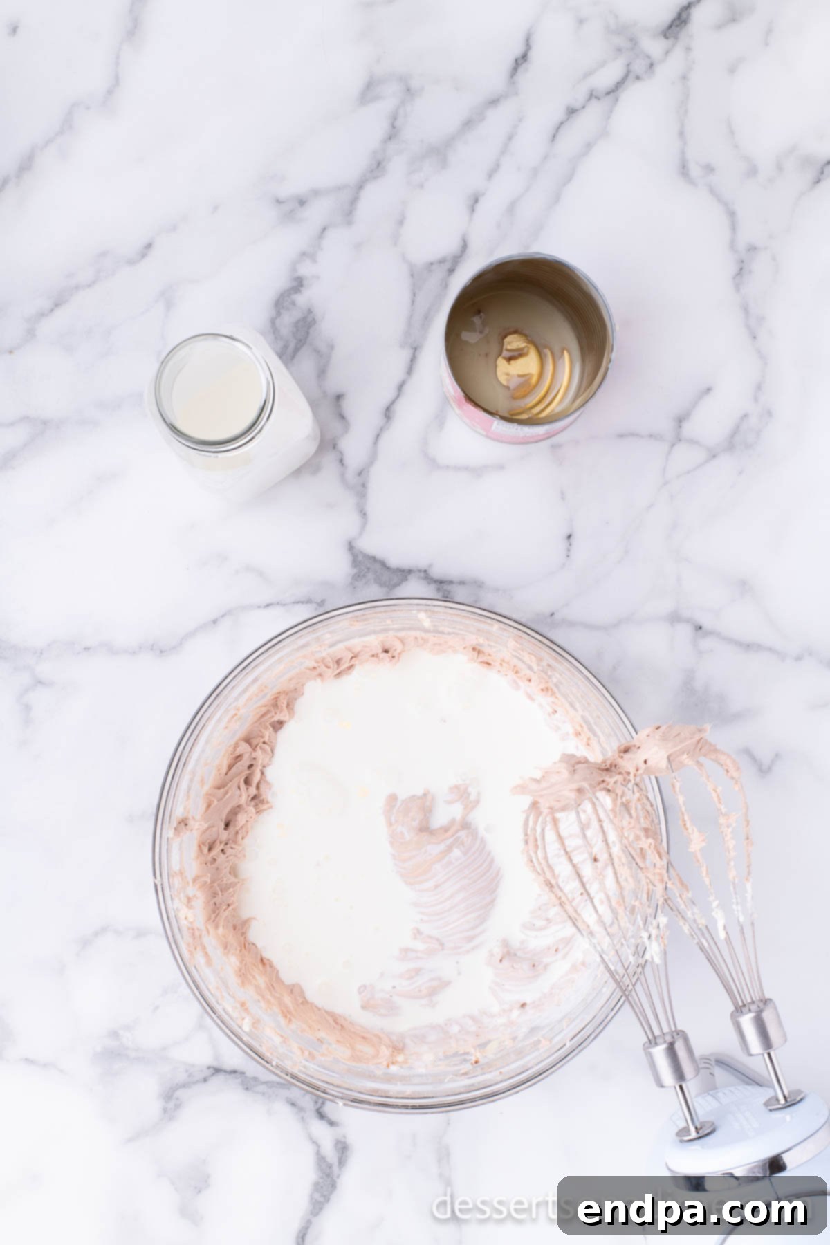 Campfire Delight Cake 9 The remaining sweetened condensed milk being added to the cream cheese mixture, ready for a final blend.