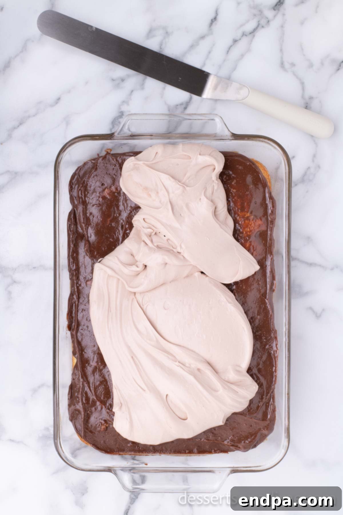 Campfire Delight Cake 10 A thick layer of chocolate buttercream evenly spread over the existing chocolate and marshmallow layers of the cake.