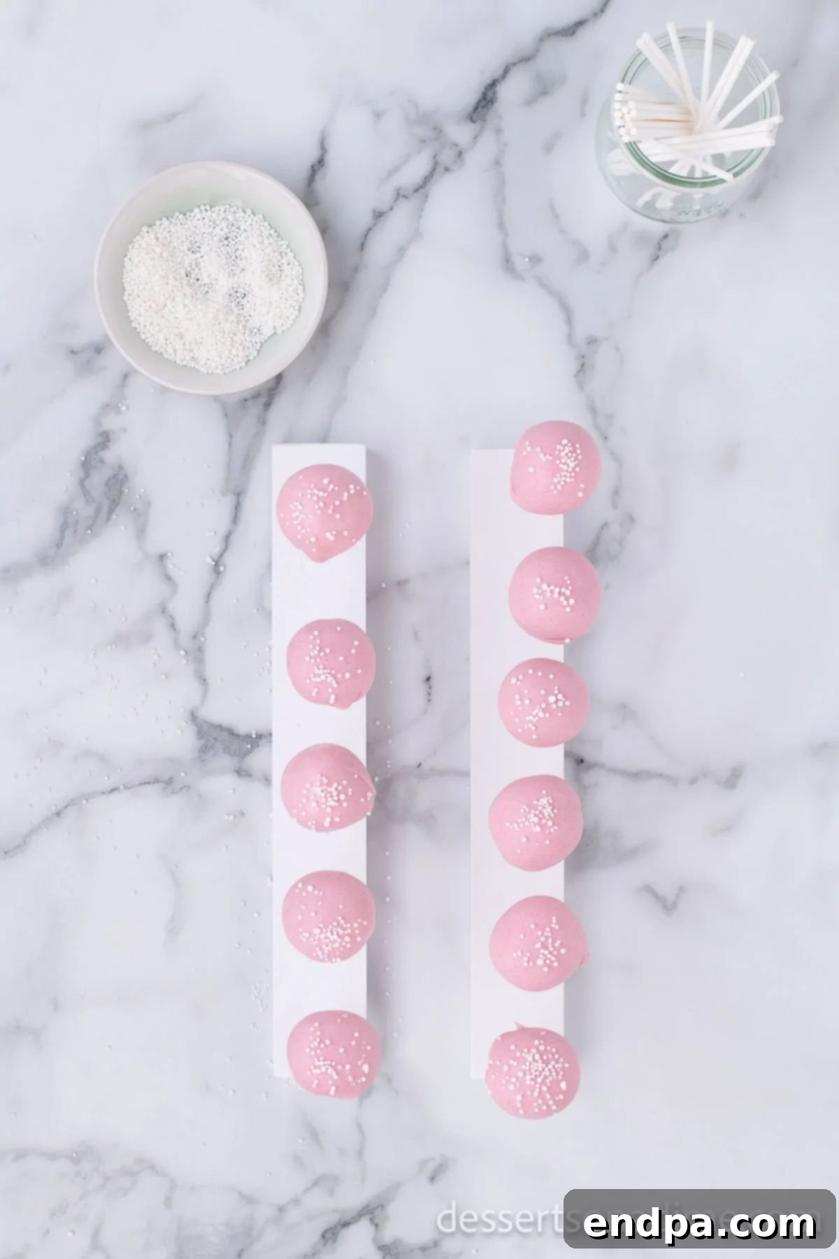 Copycat Starbucks Cake Pops 15 Finished cake pops adorned with white sprinkles.