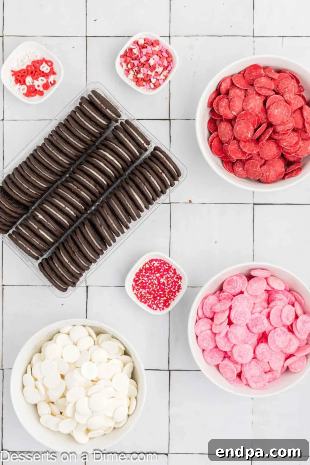 Love-Dipped Chocolate Oreos 3 Ingredients for Valentine's Oreos- oreo cookies, candy melts, sprinkles laid out on a surface.