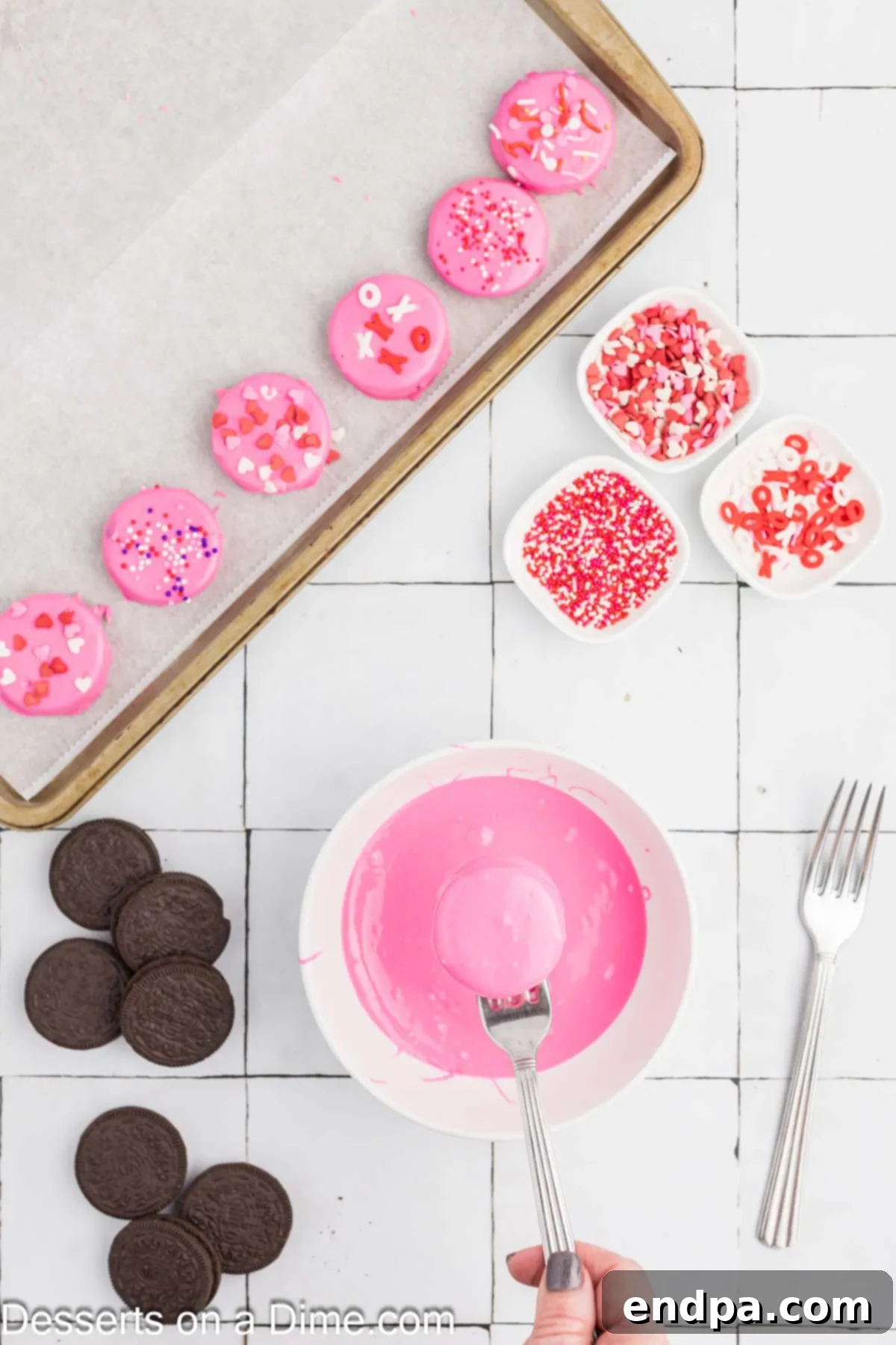 Love-Dipped Chocolate Oreos 5 Oreo cookies being dipped in a bowl with melted candy melts using a fork.