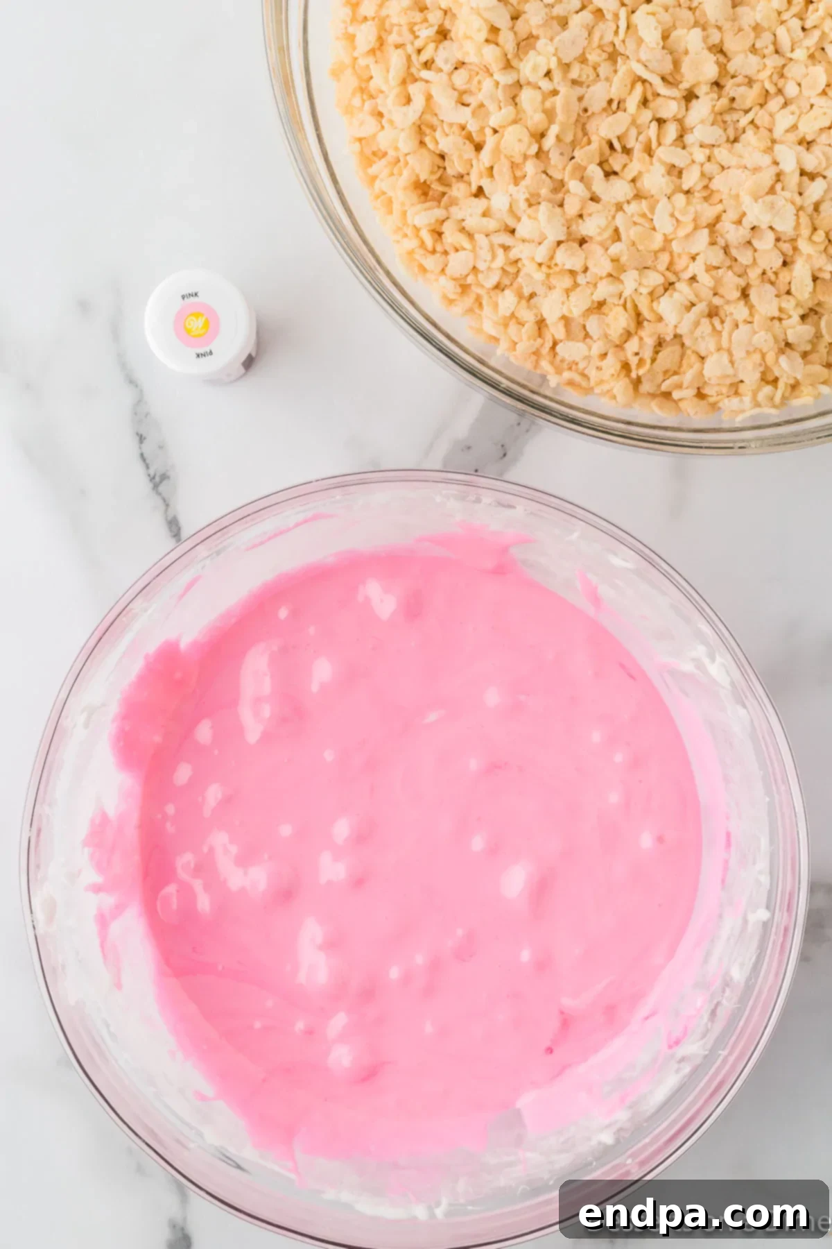 Sweetheart Crispy Treats 5 Pink food coloring added to mixture. Red food coloring being stirred into the melted marshmallow and butter.