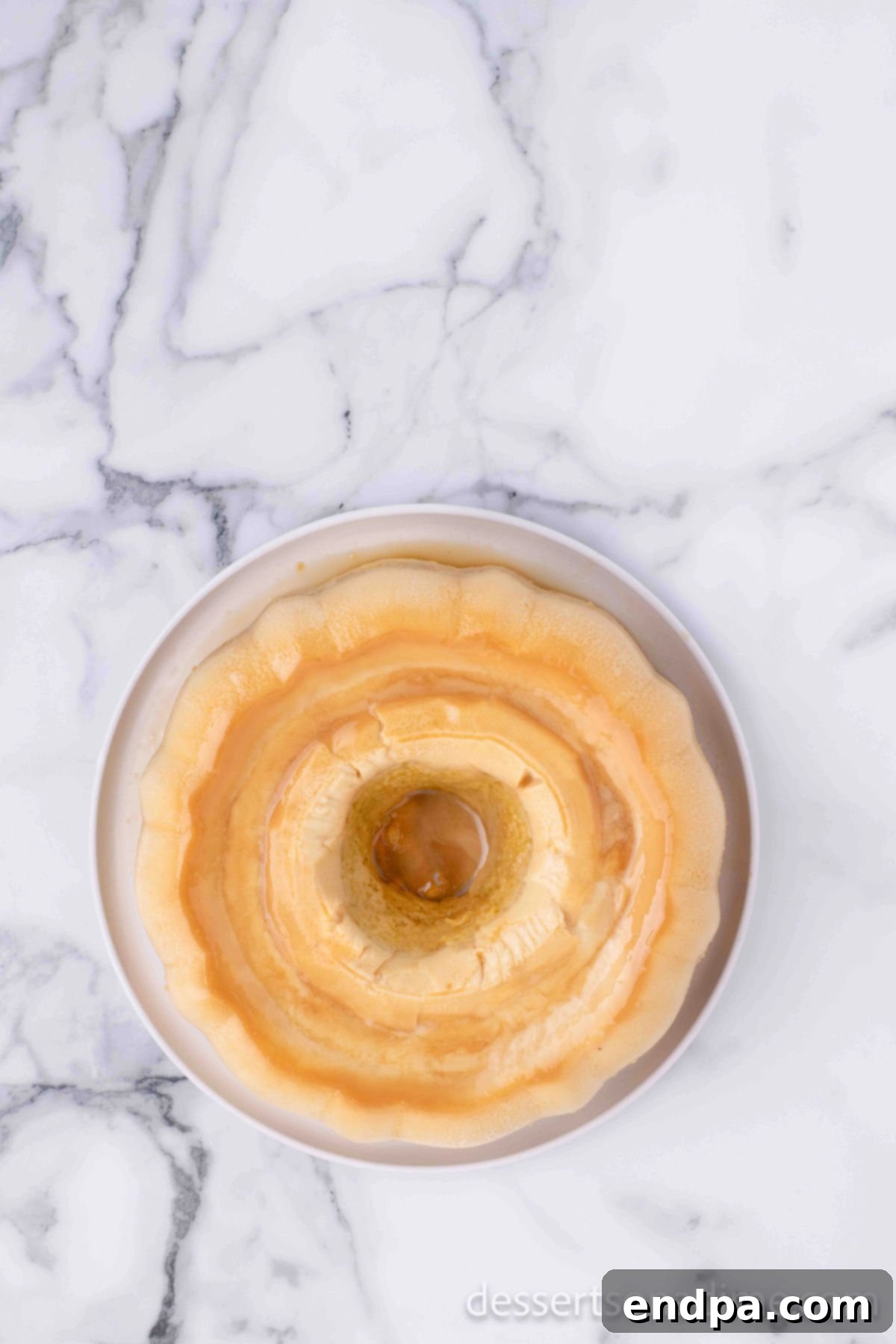 Flan cake inverted onto a platter, ready to serve.