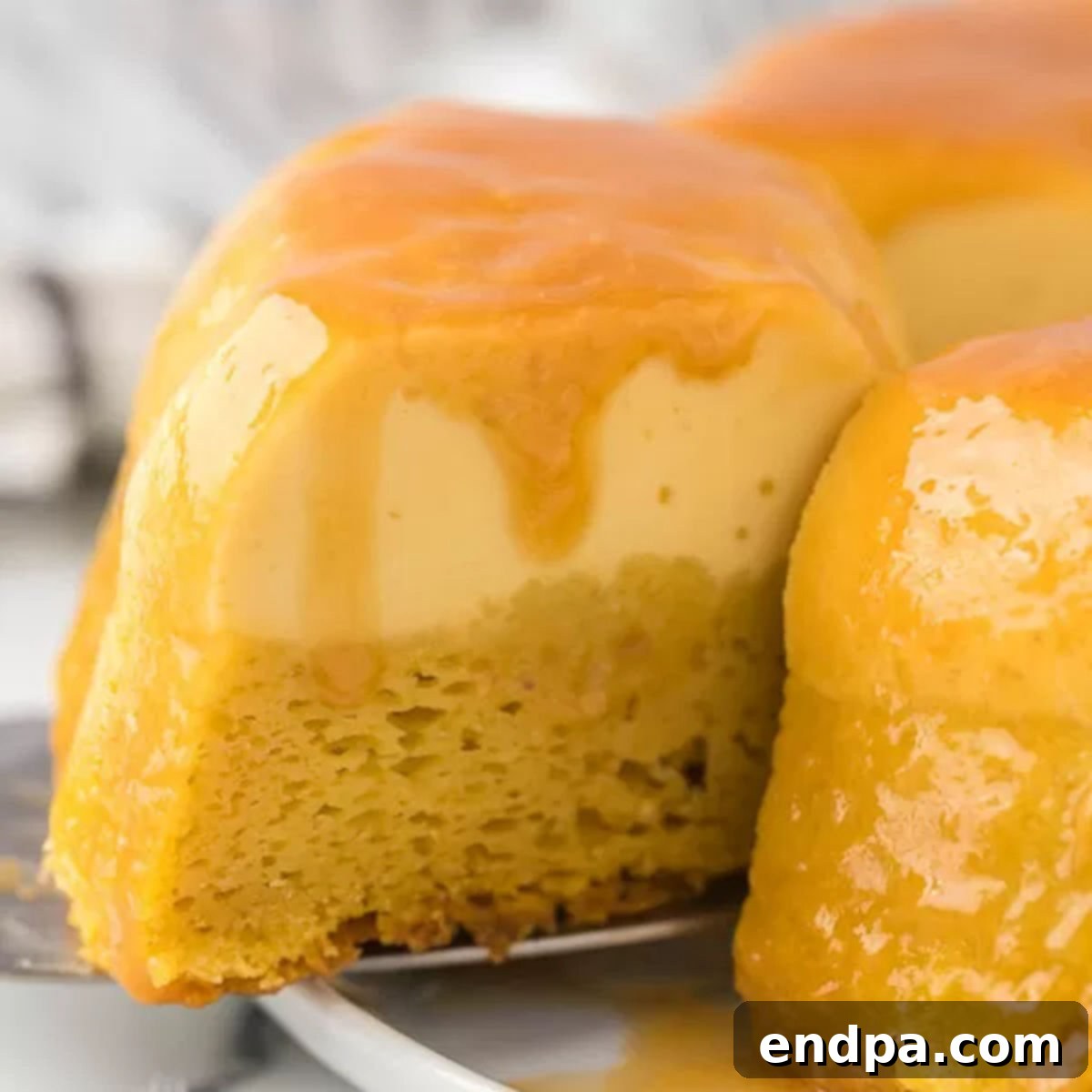 Flan cake with caramel drizzling down, ready to serve.