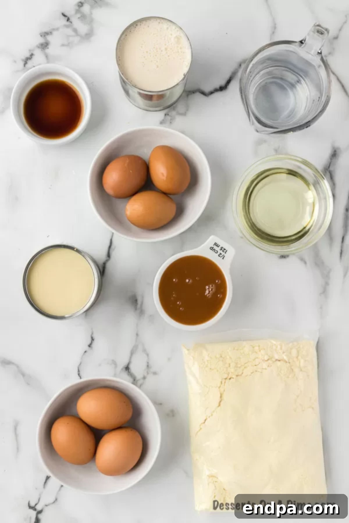 A flat lay of ingredients for flan cake, including cake mix, eggs, oil, caramel, sweetened condensed milk, and evaporated milk.
