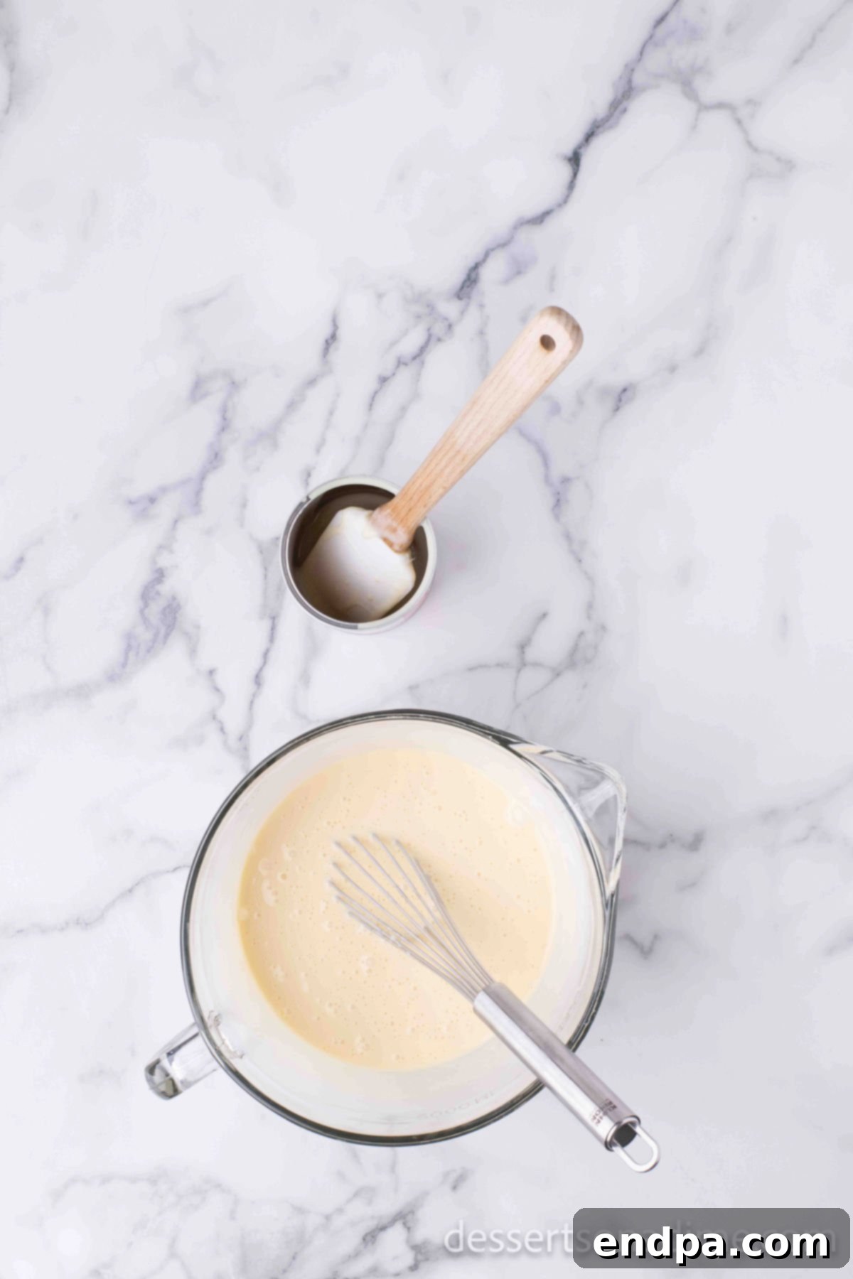 Mixing bowl with cake mix ingredients for cake batter.