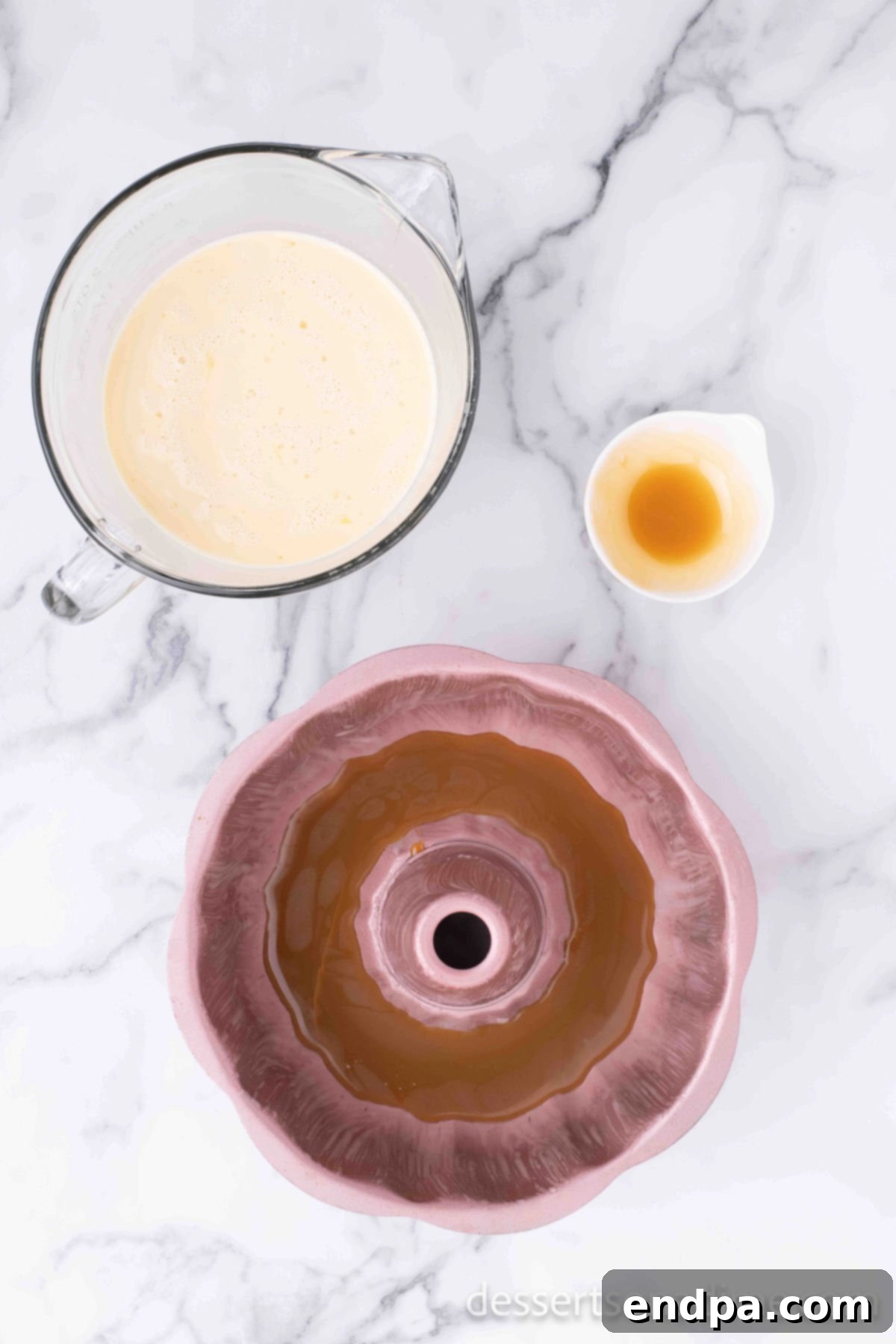 Bundt pan with caramel syrup coating the bottom.