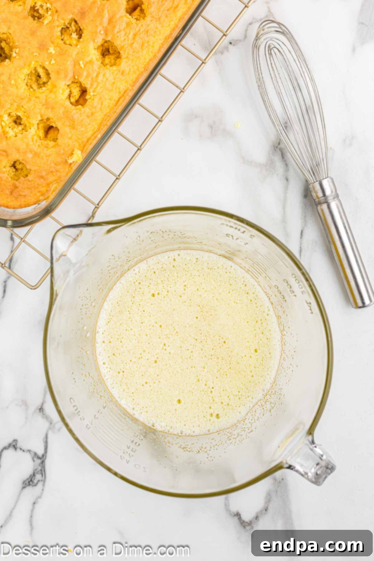 Lemon jello powder being whisked with hot water in a small bowl.