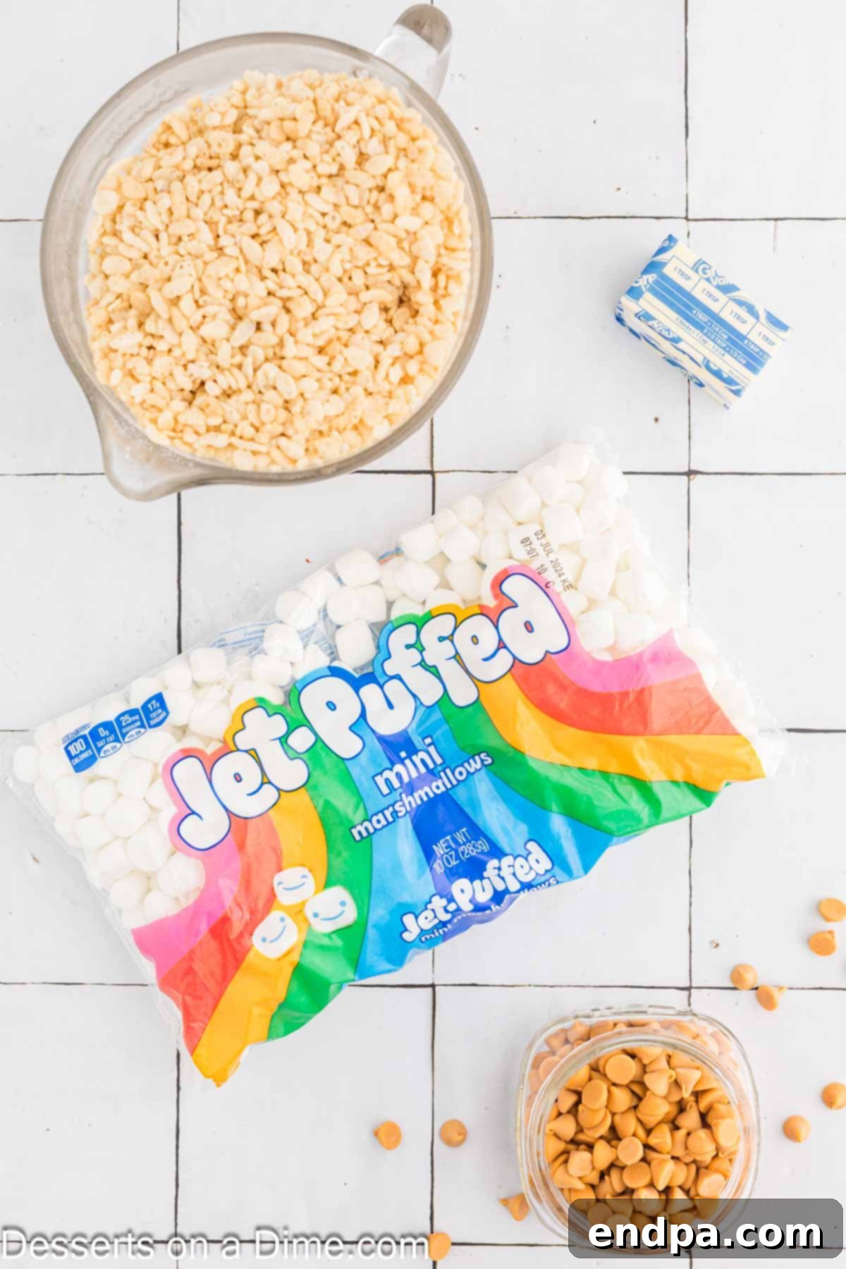 Key ingredients for Brown Butter Rice Krispy Treats: a stick of salted butter, a bag of mini marshmallows, and a box of Rice Krispies cereal.