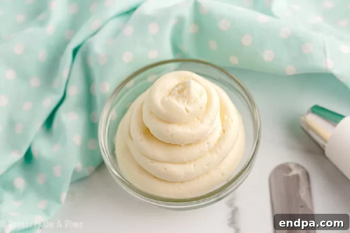 Keto cream cheese frosting ingredients combined until smooth and fluffy in a mixing bowl.
