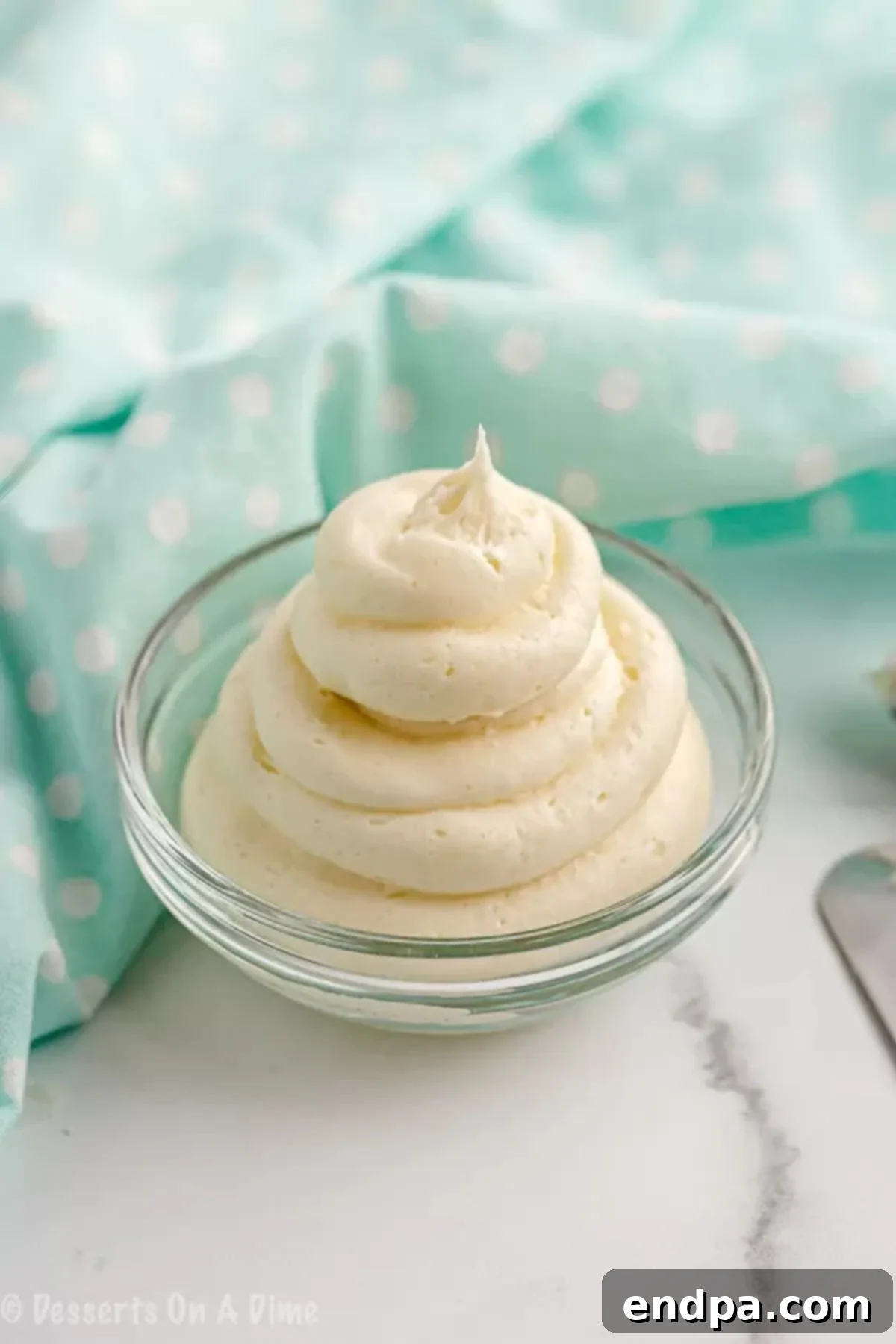 A bowl of freshly made keto cream cheese frosting, perfectly smooth and ready to spread on baked goods.