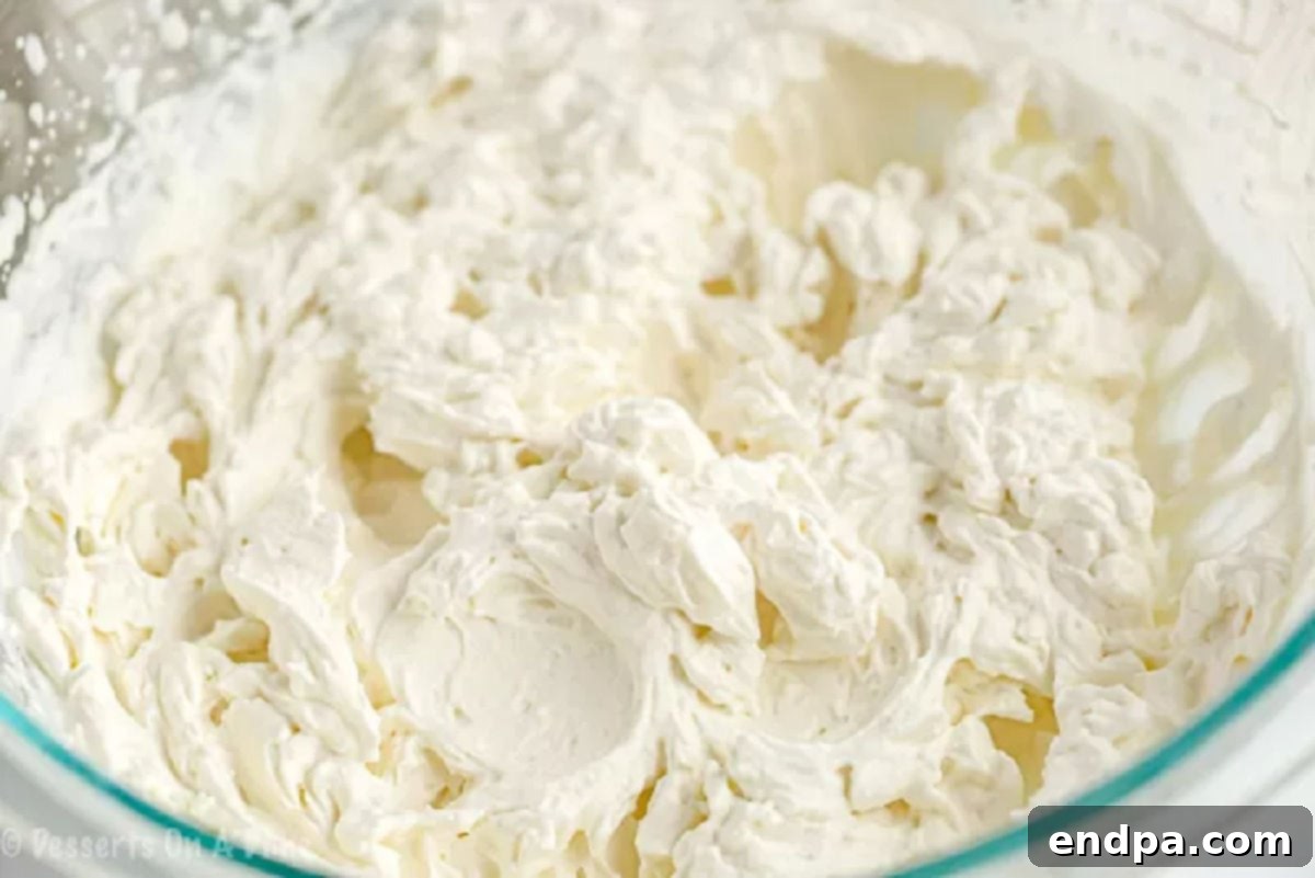 A mixing bowl filled with perfectly whipped keto cream, showing its light and fluffy texture.